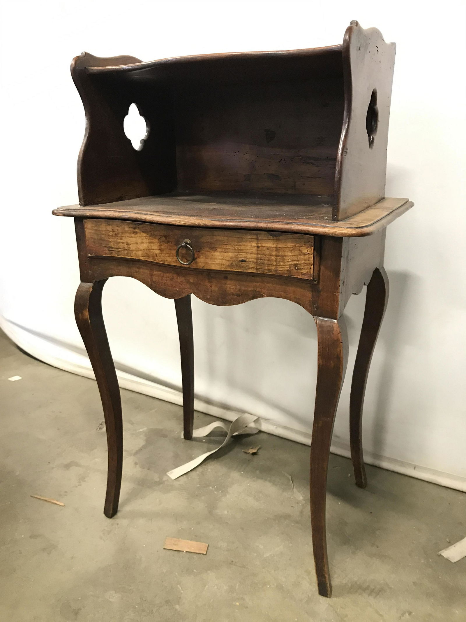 Antique Carved Wooden Side Table: Side table is wooden and antique. Piece appears to possibly be hand crafted. Table has drawer with metal loop style handle. Side table, walk stand, antique side table, lamp table, end table antique en