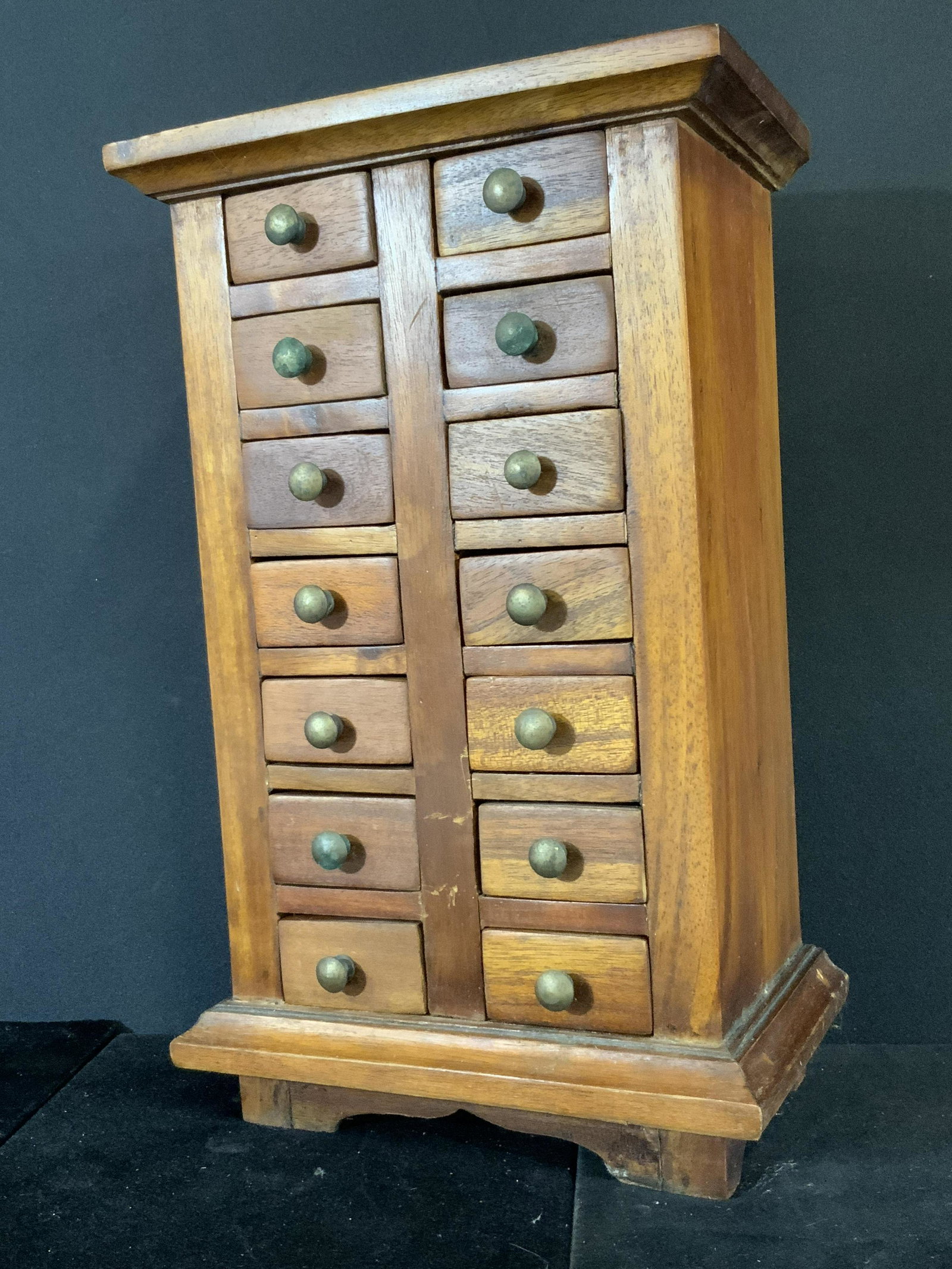 Antique Handmade Wood & Brass Spice Drawer: An antique 14 drawer spice box. Handmade from wood with brass knobs. Each drawer opens. Underside of each drawer and underside of piece is marked with writing, illegible. Up cycle in jewelry box, perf
