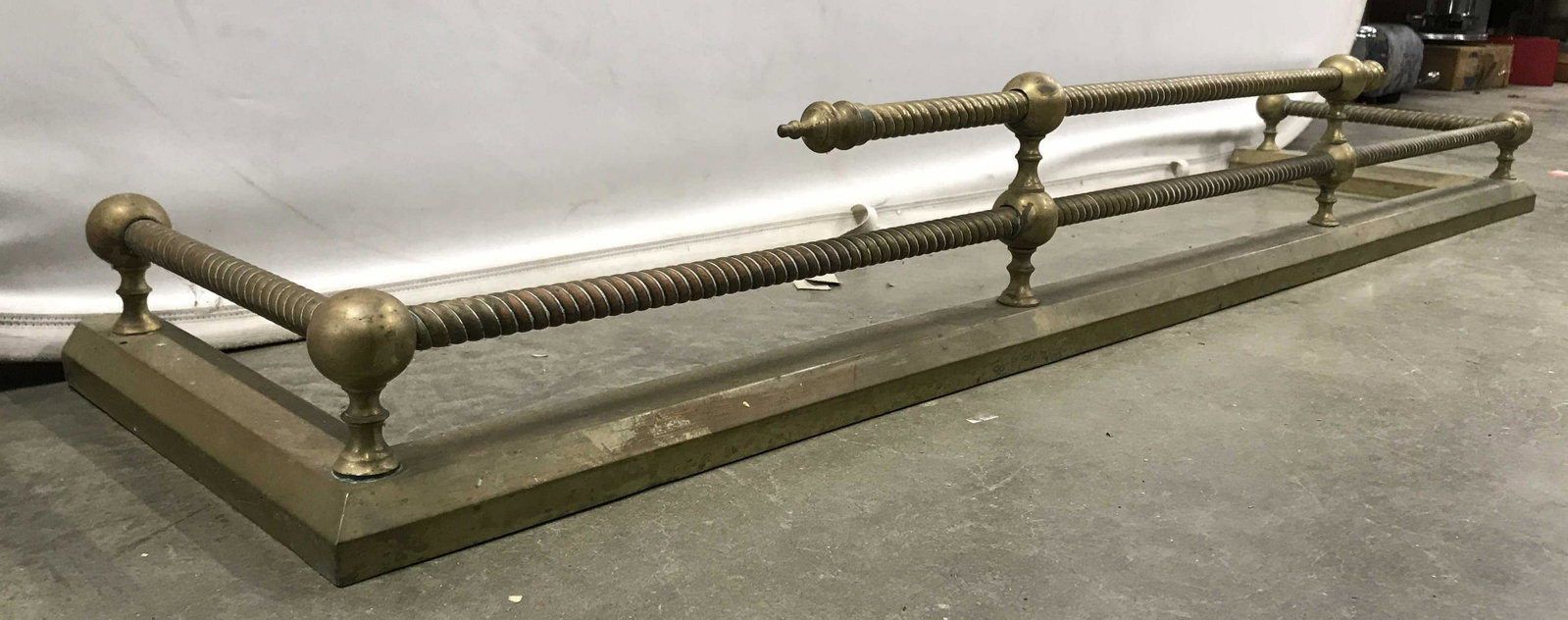 Antique Gold Toned Brass Fireplace Fender: Fireplace fender is antique. Piece is gold toned and brass. Piece measures approximately 55 inches long 13 inches deep 8 inches tall. Fireplace fender, antique fireplace fender, brass fireplace fender