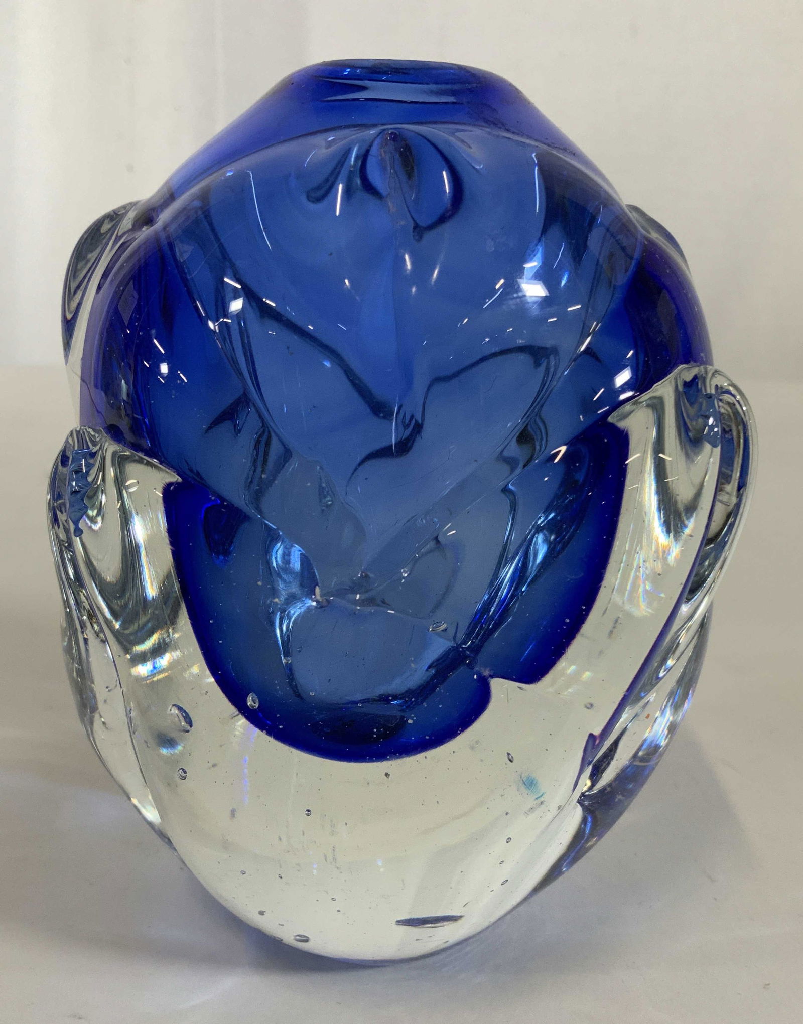 Cobalt Blue and Clear Art Glass Vase: Thick walled vase in a vase heavy art glass vase, vessel, decorative accessory, decorative object, textured surface in petal like organic form, geometric artichoke elliptical, inside has appearance of