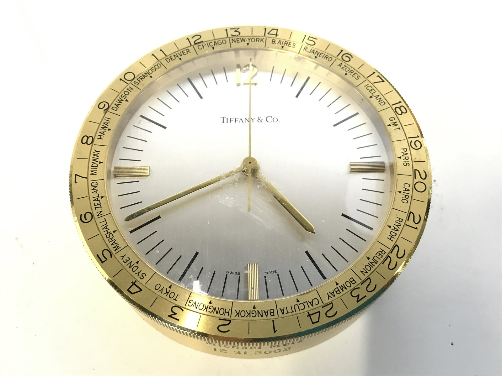 TIFFANY & CO Monogrammed Desk Clock: Clock face reads TIFFANY & CO SWISS MADE. Piece is monogrammed on base front and back. Piece has names of various major cities on perimeter. Desk clock, Tiffany And company, Tiffany and company clock,