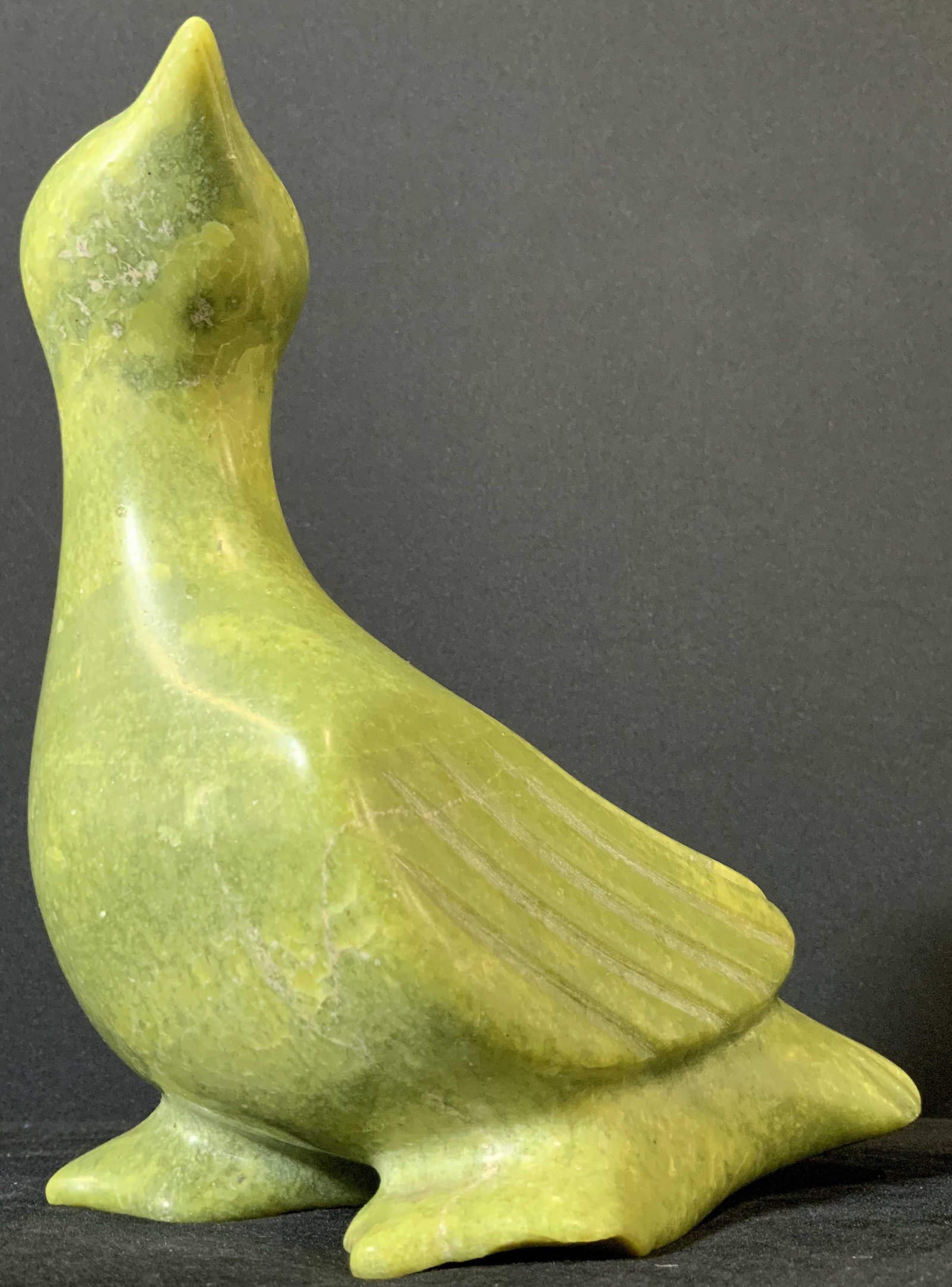 Vintage Asian LEMON JADE Standing Bird Carving: A vintage carving of a bird jade from Lemon Jade stone. The bird is a combination of green and yellow hues. It has etched details along its wings and face. Overall, the bird is polished and smooth to 