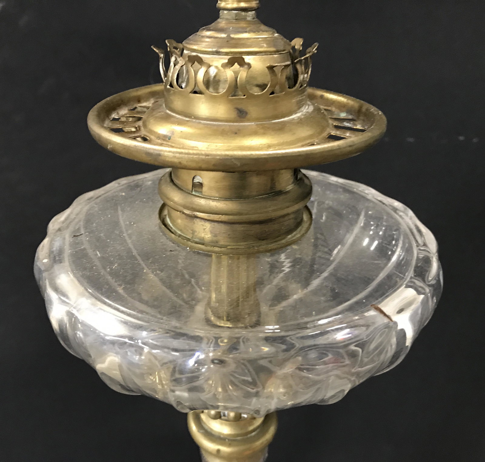 Antique Brass & Glass Victorian Floor Lamp: Lamp is floor sized. Piece is antique, has Victorian style. Piece has brass bass with ornate detail. Lamp has 2 bulb sockets with pull switches. Center of piece has glass structure. Piece measures app