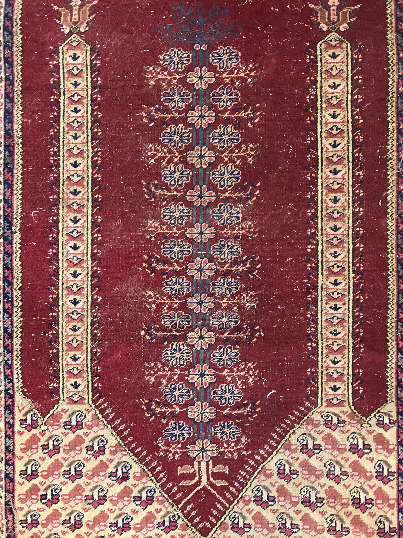 Vintage Fringed Wool Area Rug: Rug is wool and handmade. Piece is vintage possibly antique. Rug contains intricate floral detailing. Piece measures approximately 74 in by 47 inches wide. Rug, carpet, area rug, wool rug, handmade ru