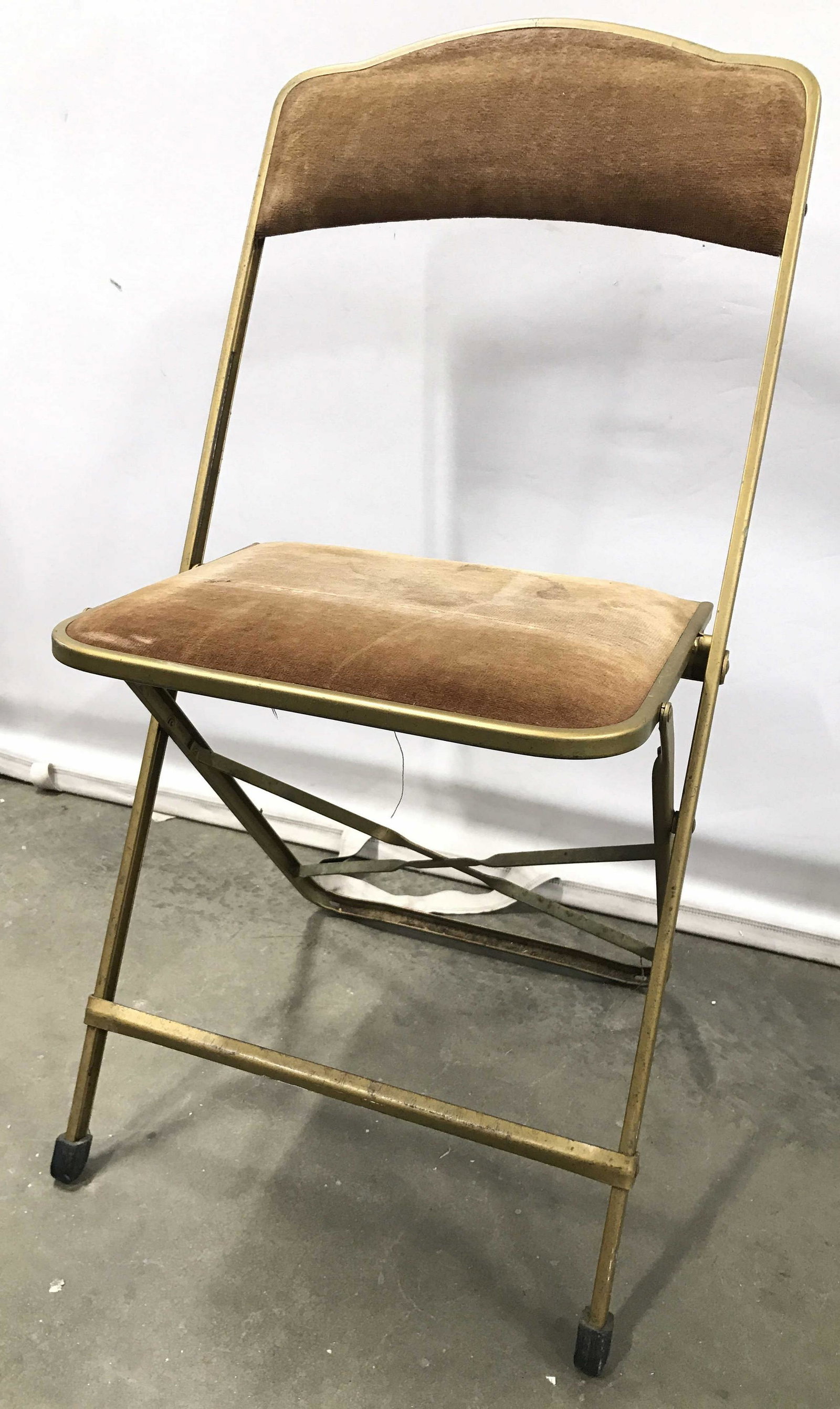 Vintage Cushioned Metal Folding Chair: Folding chair has gold toned frame & beige toned. Piece is vintage. Chair, side chair, folding chair, metal folding chair, cushioned folding chair. seating, Measures approximately 32 18 inches wide 17