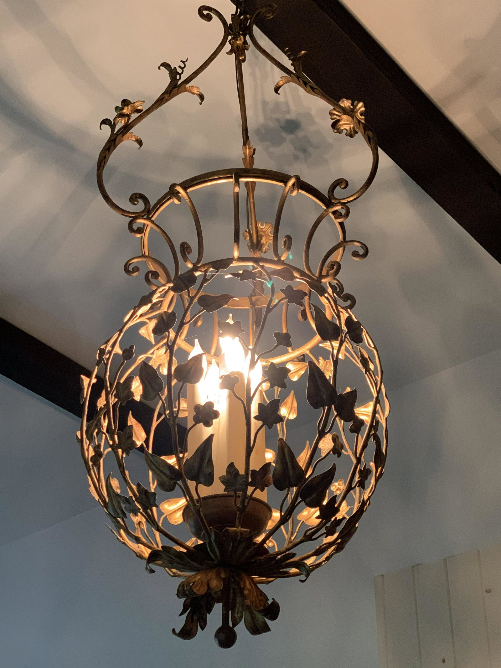 Vintage Ornate Gilded Bronze Chandelier: Vintage, possibly antique, gilded bronze chandelier. Chandelier resembles a series of flowering vines. Cluster holds 5 bulbs, sockets resemble candles. Measures approx 53 inches H, and 20 inches W. We
