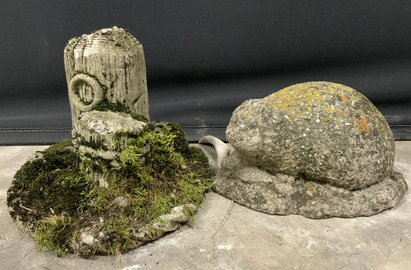 Lot 2 Stone Garden Ornaments: Lot includes two garden ornaments, both vintage, possibly antique. One resembles a hedgehog, the other logs wrapped in rope. Wear is consistent with age and exposure. Largest measures approx 7.5 inche