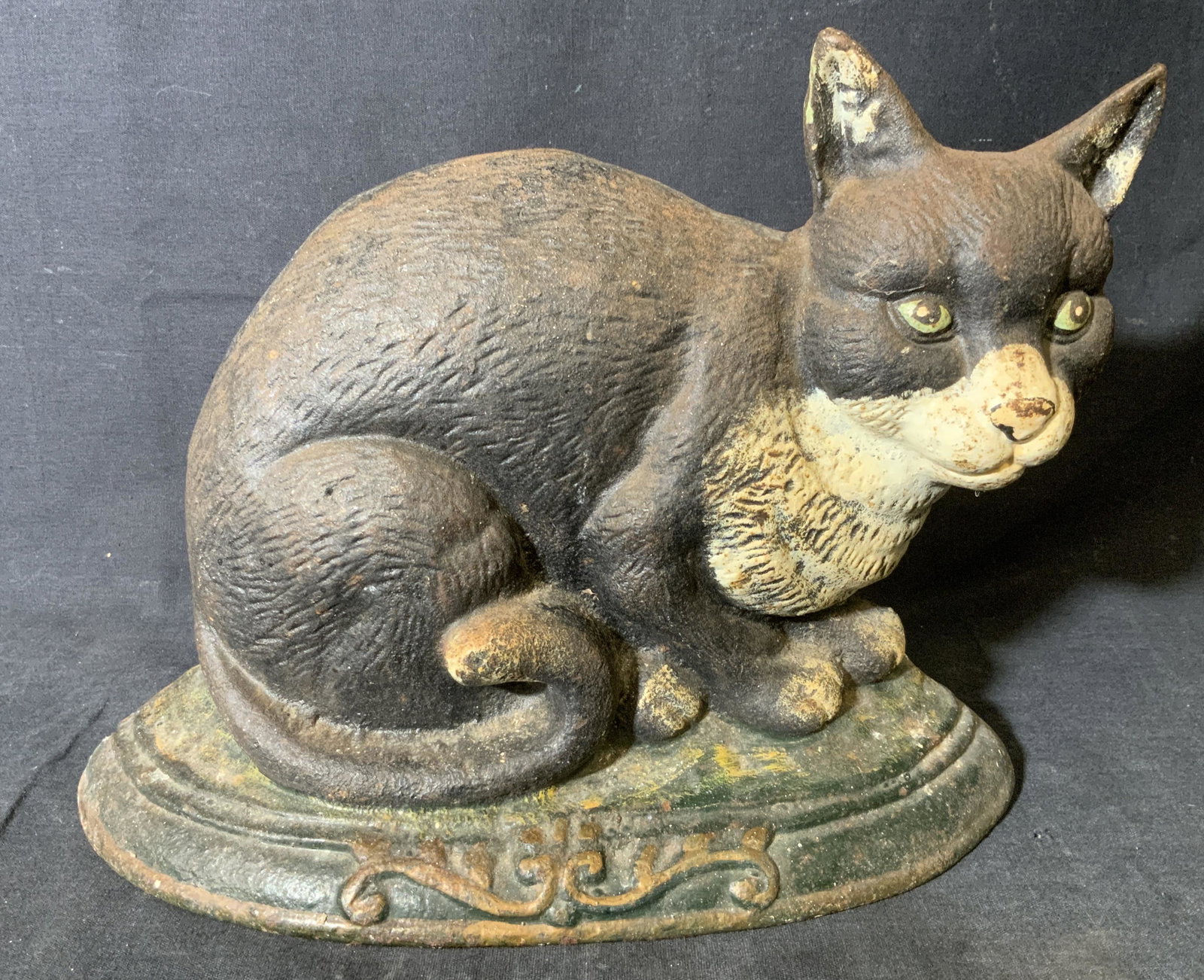 Vintage Hand Painted Cast Iron Cat Door Stop: Vintage Hand Painted Cast Iron Cat Door Stop, vintage possibly antique, no apparent inscriptions or signatures, subject a black and white cat perched on a green platform, some chips and wear to paint 