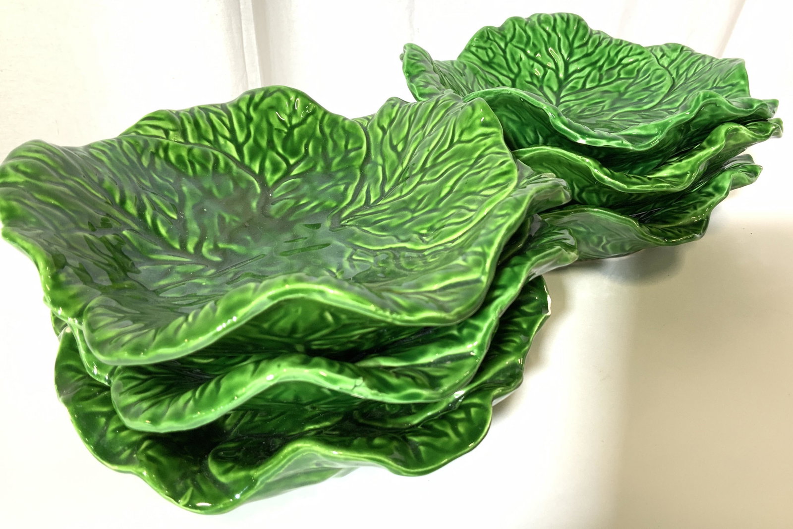 Set 6 Glazed Cabbage Form Tabletop Bowls: Handmade ceramic bowls, cabbage pattern, glazed bright green, each on varies in form and size , app measures 8.5 in. diameter app 2.25 in. Ht. chip to a couple on rim. tableware, decorative accessory,