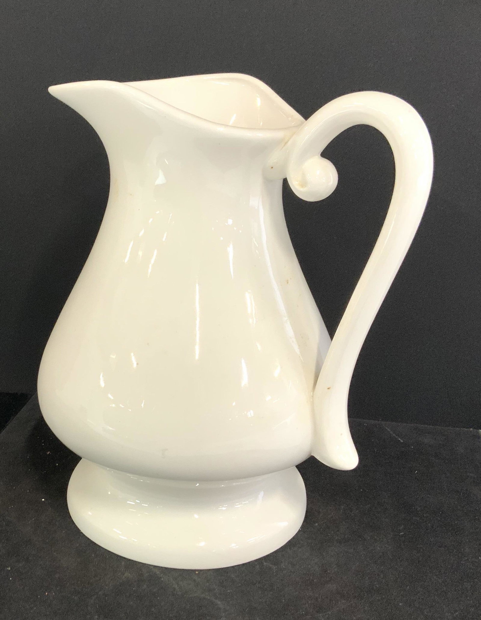 Glazed Minimalist Stoneware,Ceramic Pitcher: Pitcher Jug, cream color, large handle, short pedestal base, stone ware, ceramic, porcelain, pottery pitcher, vase, vessel,10.5 in. Ht. 9 in. W use for summer drinks, water or as a vase. Property of J