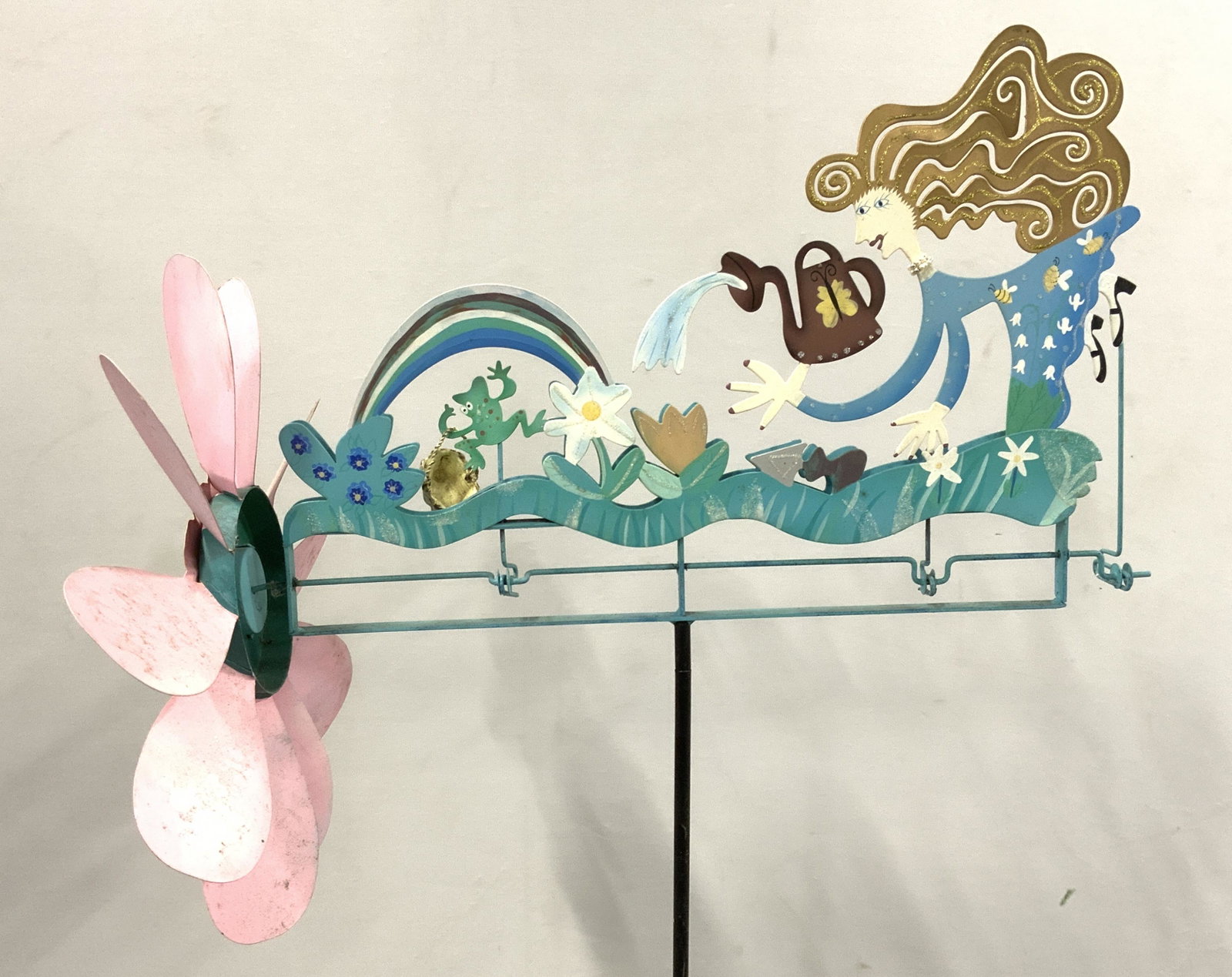 Signed ROSSI FOR SILVESTRI Vntg Folk Art Whirligig: Whirligig is signed ROSSI FOR SILVESTRI. Piece appears to possibly be hand painted. Top of whirligig depicts a female figure watering plants. Flower structure on front of piece rotates which moves fro