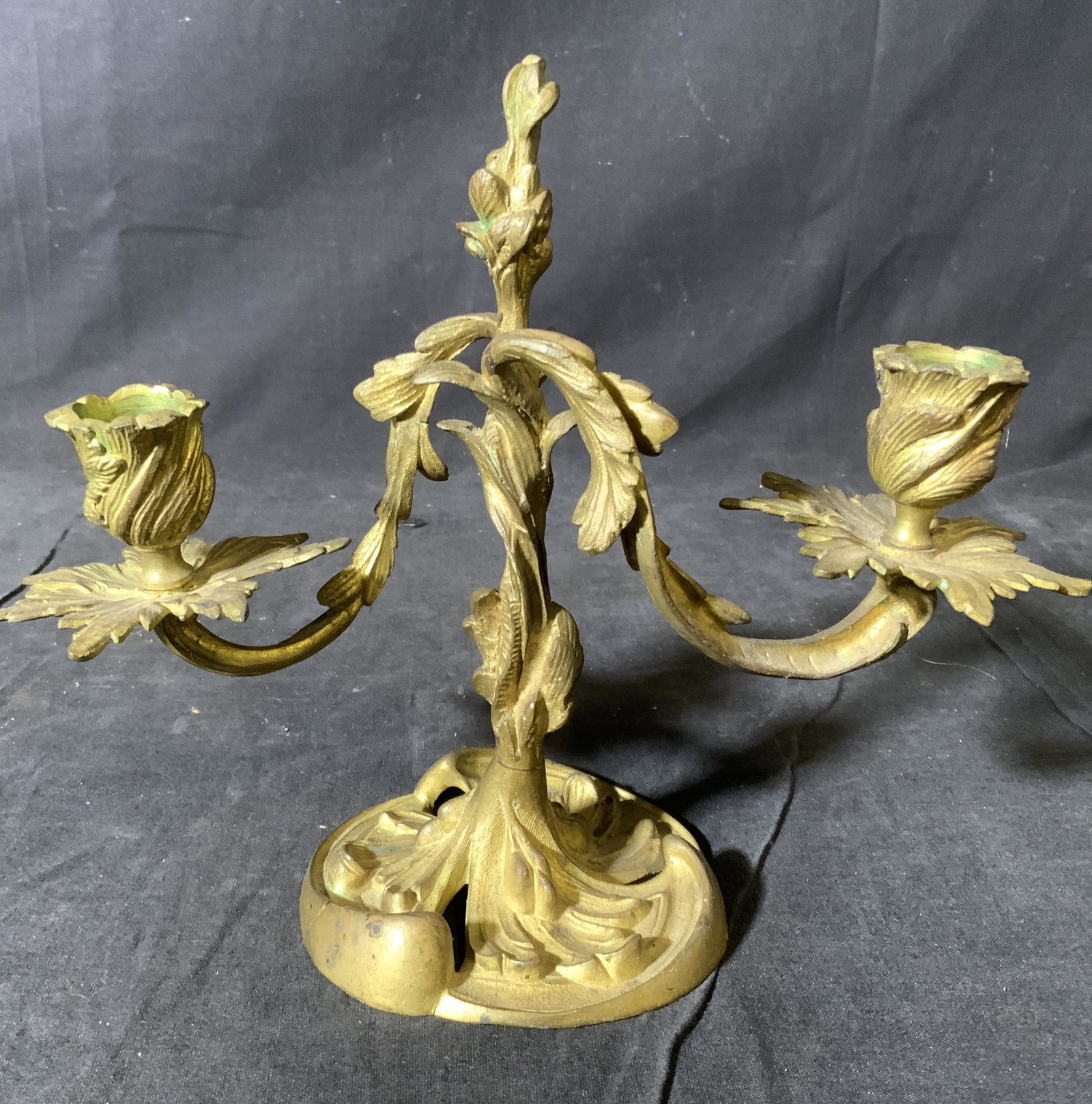 Antique Gilded Bronze 2 Arm Candelabra: Candelabra is vintage possibly antique. Piece is gold toned metal bronze or brass, gilded bronze has weight, . Candelabra hAS 2 arms. Piece has ornately detailed structures. Piece measures approx 8 in