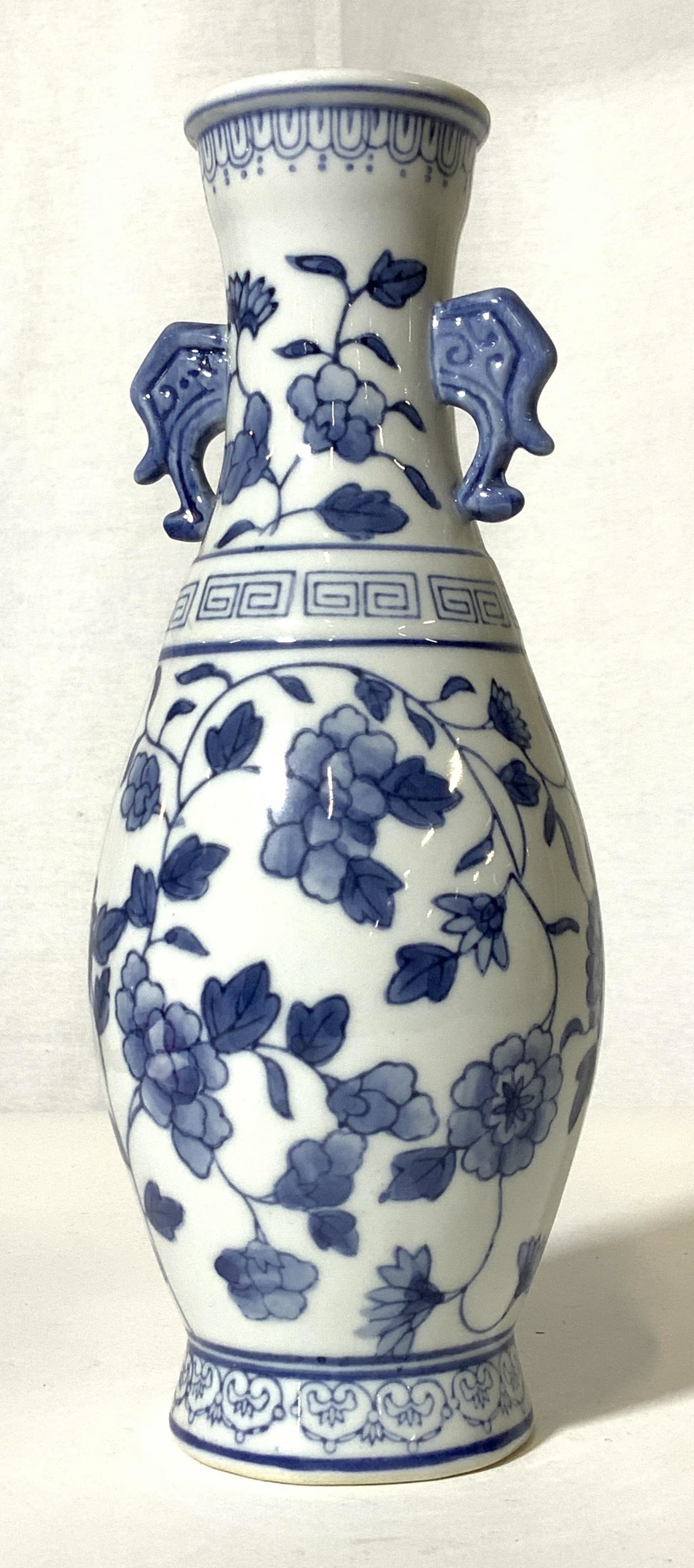 FAMILLE ROSE Blue & White Chinese Porcelain Vase: White porcelain vase decorated with famille rose pattern in blue. Vase neck with twin handles, angular and soft thunder cloud decor. Piece ht 10 in. Widest width 4 in. Underside Hallmarked ‘ made in