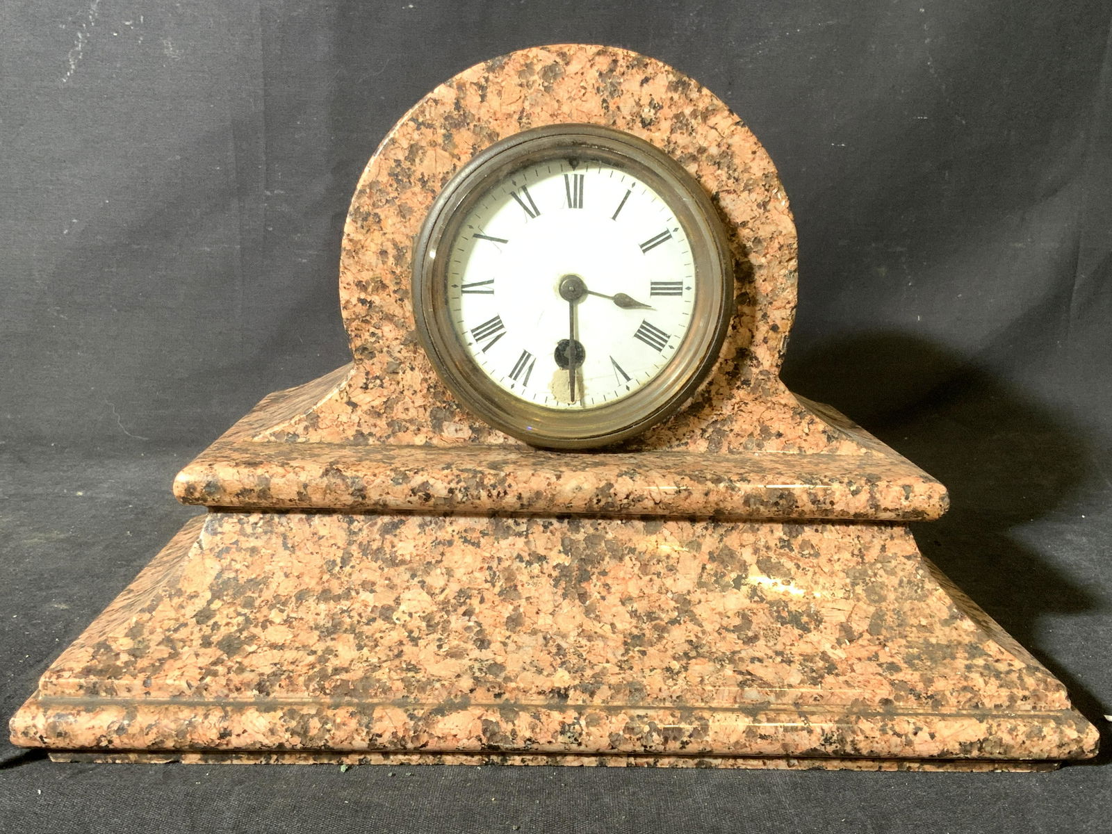 Vintage Marble Mantel Clock W Roman Numerals: Mantel clock is vintage possibly antique. Interior reads RC. Piece has tones of black and coral. Piece has white toned clock face with black toned Roman numerals. Piece measures approx 11 inches long