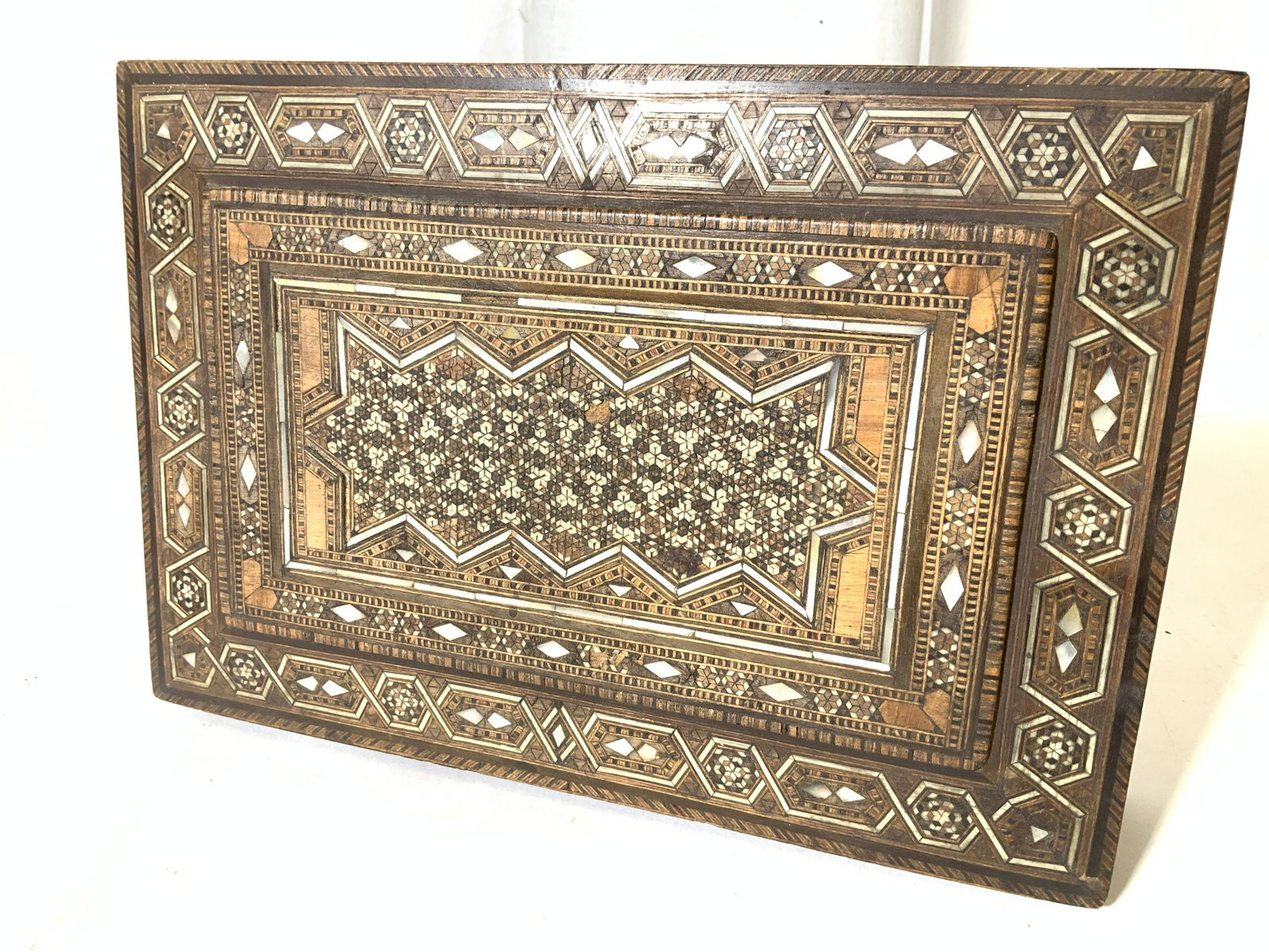Inlaid Mother of Pearl wooden Keepsake Box, Spain: Vintage Keepsake wood box with intricate multi toned inlaid middle eastern (Arabic) pattern, including bars of mother of Pearl detail. All handmade. This box possibly held cigars, jewelry, document bo