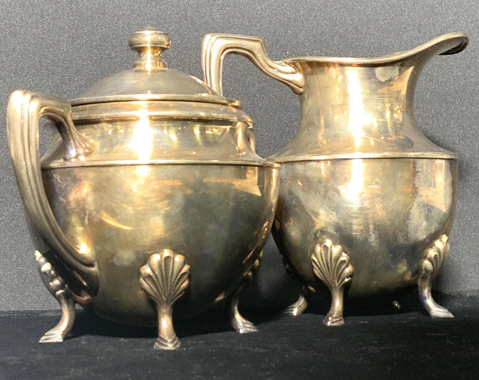 Set 2 CRESCENT Signed Vntg Silver Plate Tableware: Circa 1930s vintage silver plated metal tableware. A sugar bowl and a creamer. Both pieces have embossed metal feet and etched handles. The creamer has one handle while the sugar bowl has two twin han