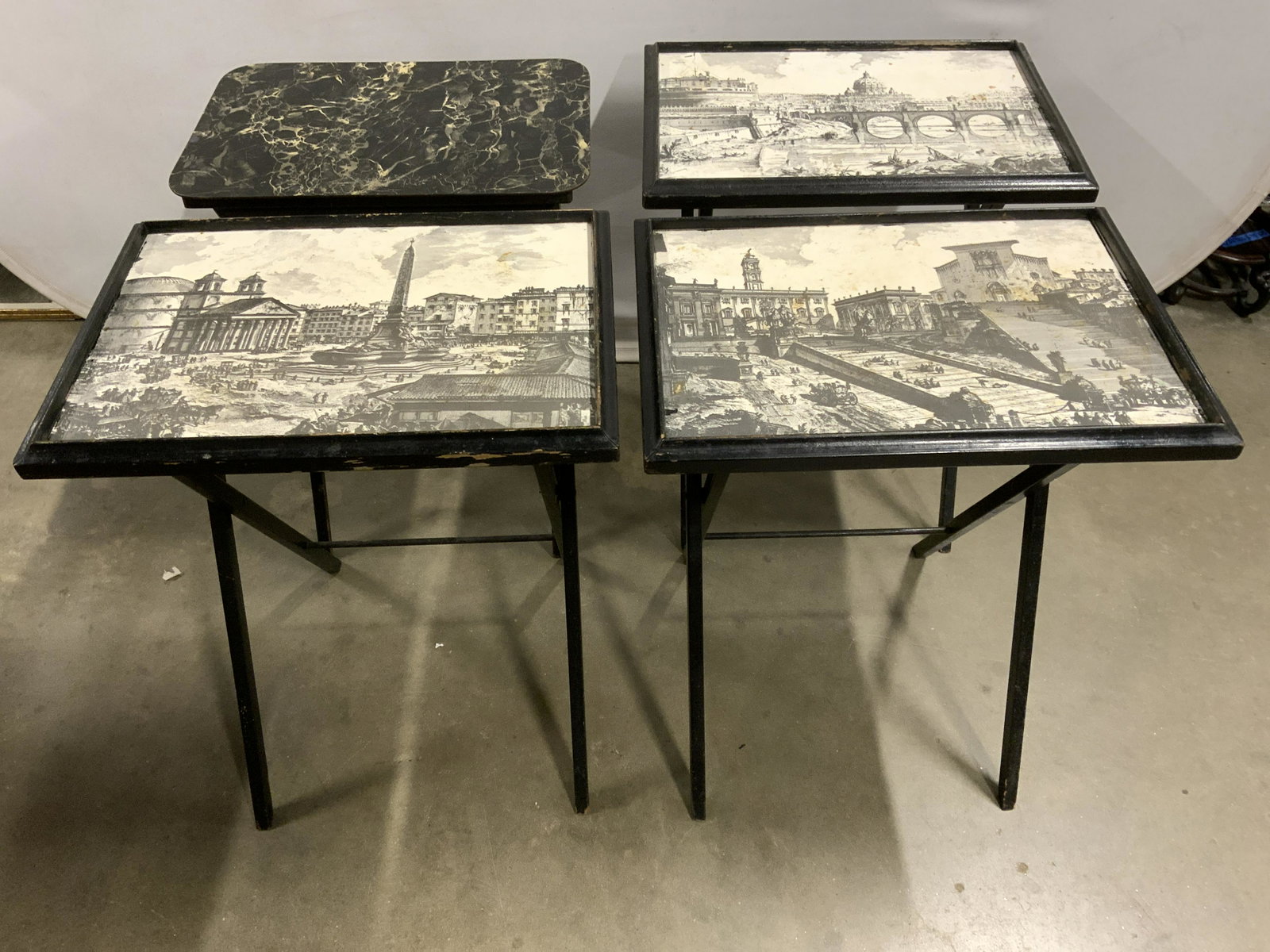 Lot 4 Vintage Tray Tables W Printed Tops: Lot includes 4 tray tables. 3 out of 4 tables have tops with printed detail depicting various destinations. One tabletop resembles appearance of marble. Each measures approx 25 inches tall 21 inches w