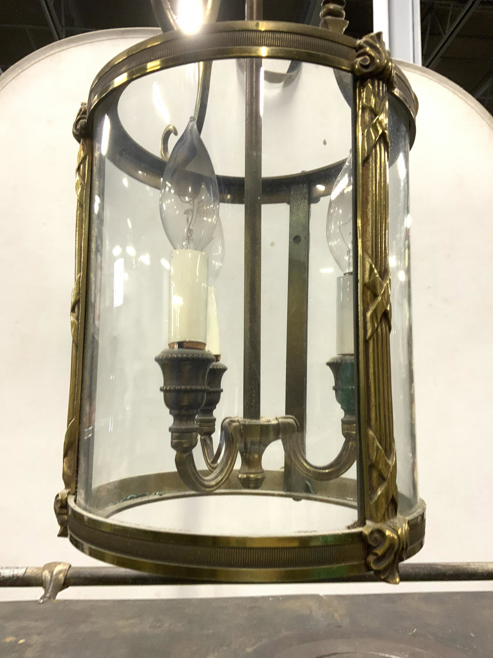 Vintage 3 Arm Brass & Glass Hanging Chandelier: Chandelier is vintage possibly antique. Frame of piece is brass. Chandelier also has 3 curved glass panels. Top half has 3 s curve structures. Piece measures approx 26 inches tall 8 inches wide. Chand