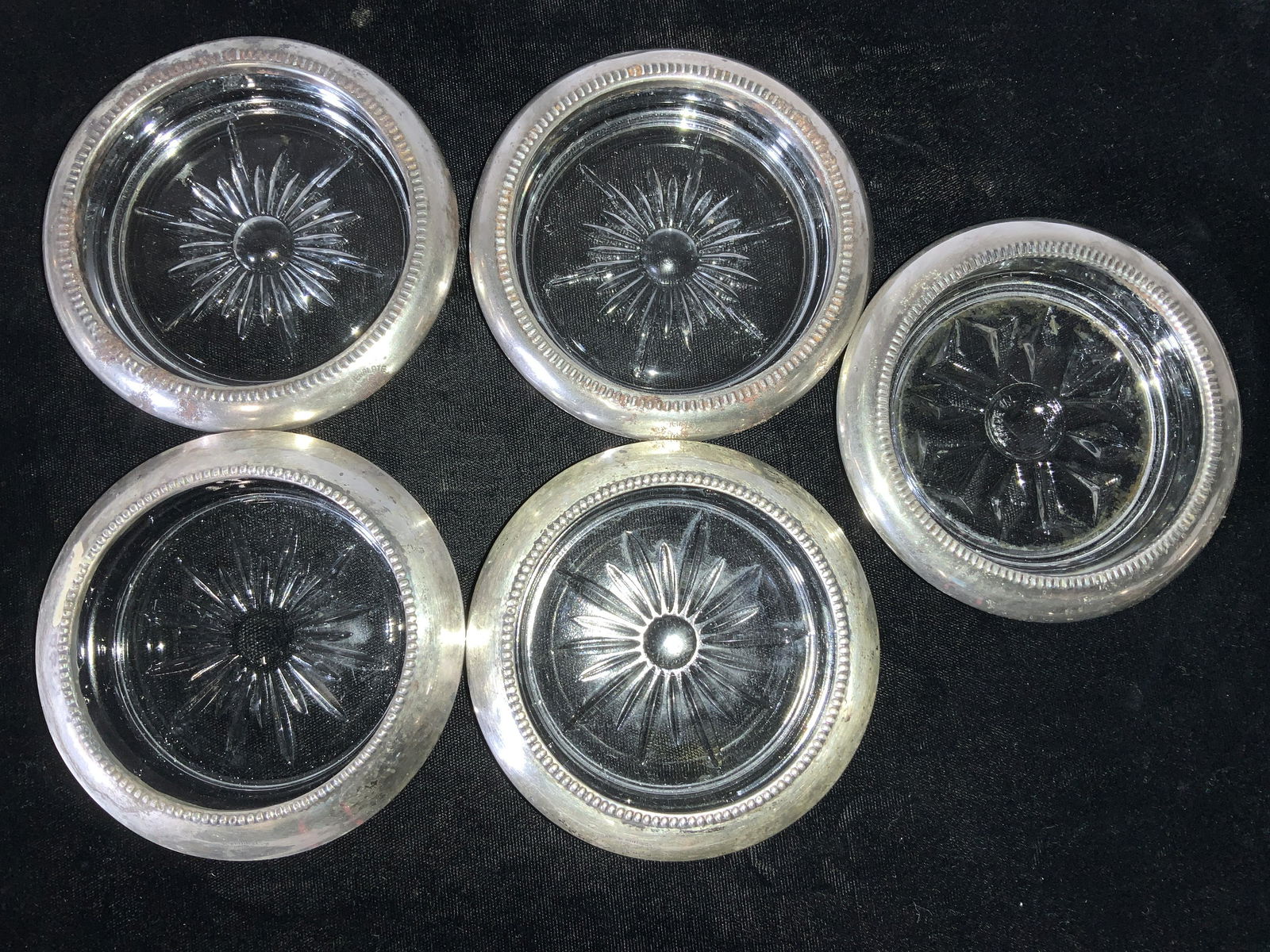 Set 5 SILVER & PLATED Cut Glass Coasters, Italy: Vintage Cut glass coasters with different star / snowflake design. Encased in silver or silver plated rims. 2 Hallmarked ‘SILVER Frank M Whiting & Co. 04 Pat pending ‘ 2 Hallmarked Silver plate It