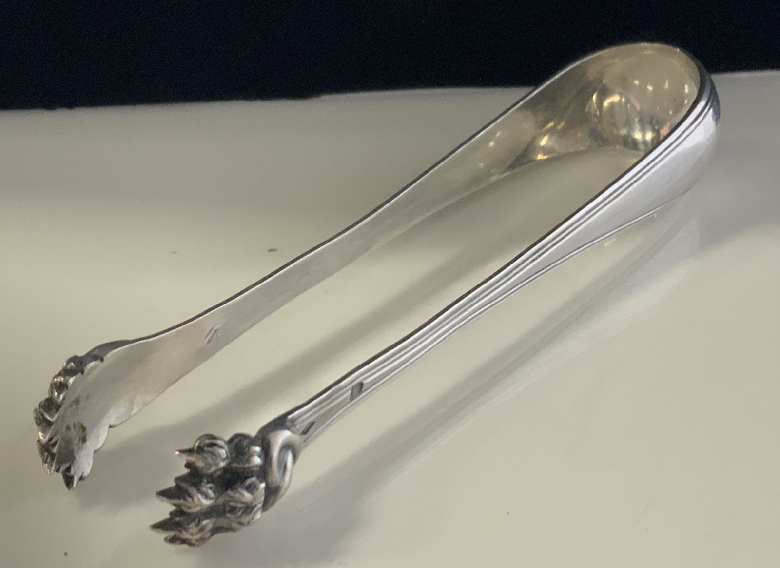 P&B STERLING SILVER LION CLAW TONGS, Vintage: Hallmarked for Sterling. Dramatic lion claw feet tongs, chased in relief. Simple handle pattern. Impressed P& B trademark with pelican, others illegible. 5.25 in. L use for Ice cubes, sugar cubes, as 