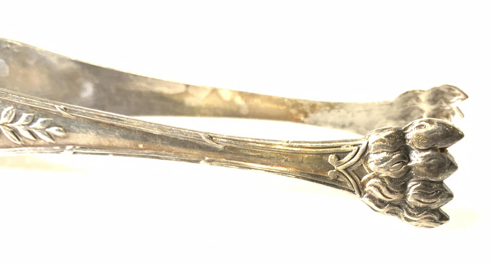 Silver Plated Claw Foot Vintage Tongs: claw footed tongs, chased & in relief. Victorian pattern with bow, wreath, and laurel. Impressed trademark ‘ 2 G’ 5.25 in. L Use for Ice cubes, sugar cubes, as petite four tongs. 1.22 ozt. silver 