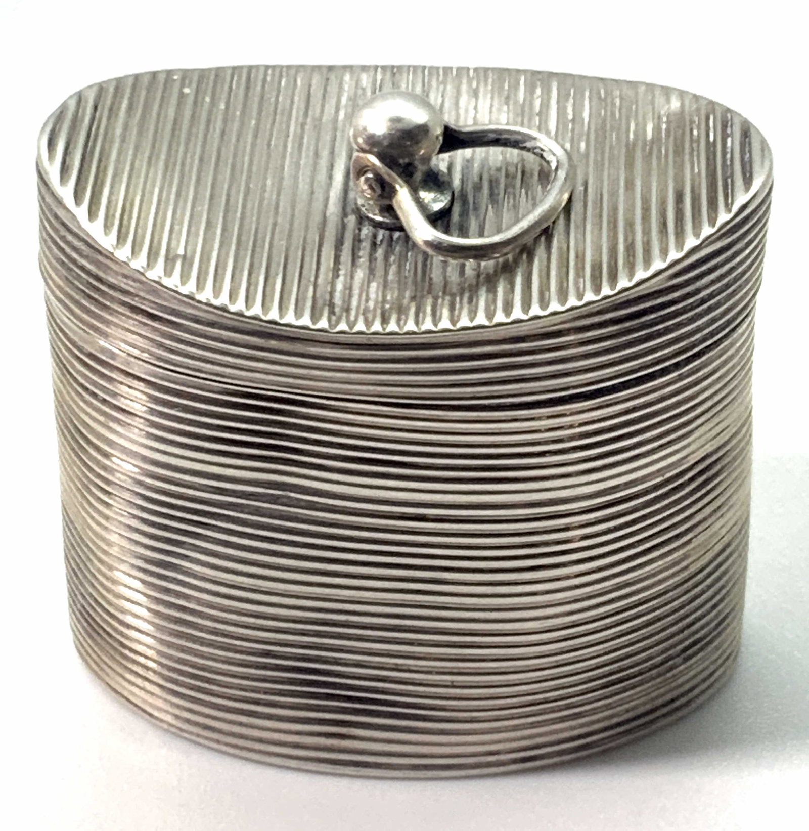 Antq Dutch Sterling Silver Etched Bands Pill Box: An antique (circa 1840s) Dutch sterling silver pill box. This hinged pill box also features a small handle connected to the top. The handle is attached to where the pill box decoratively dips. The han