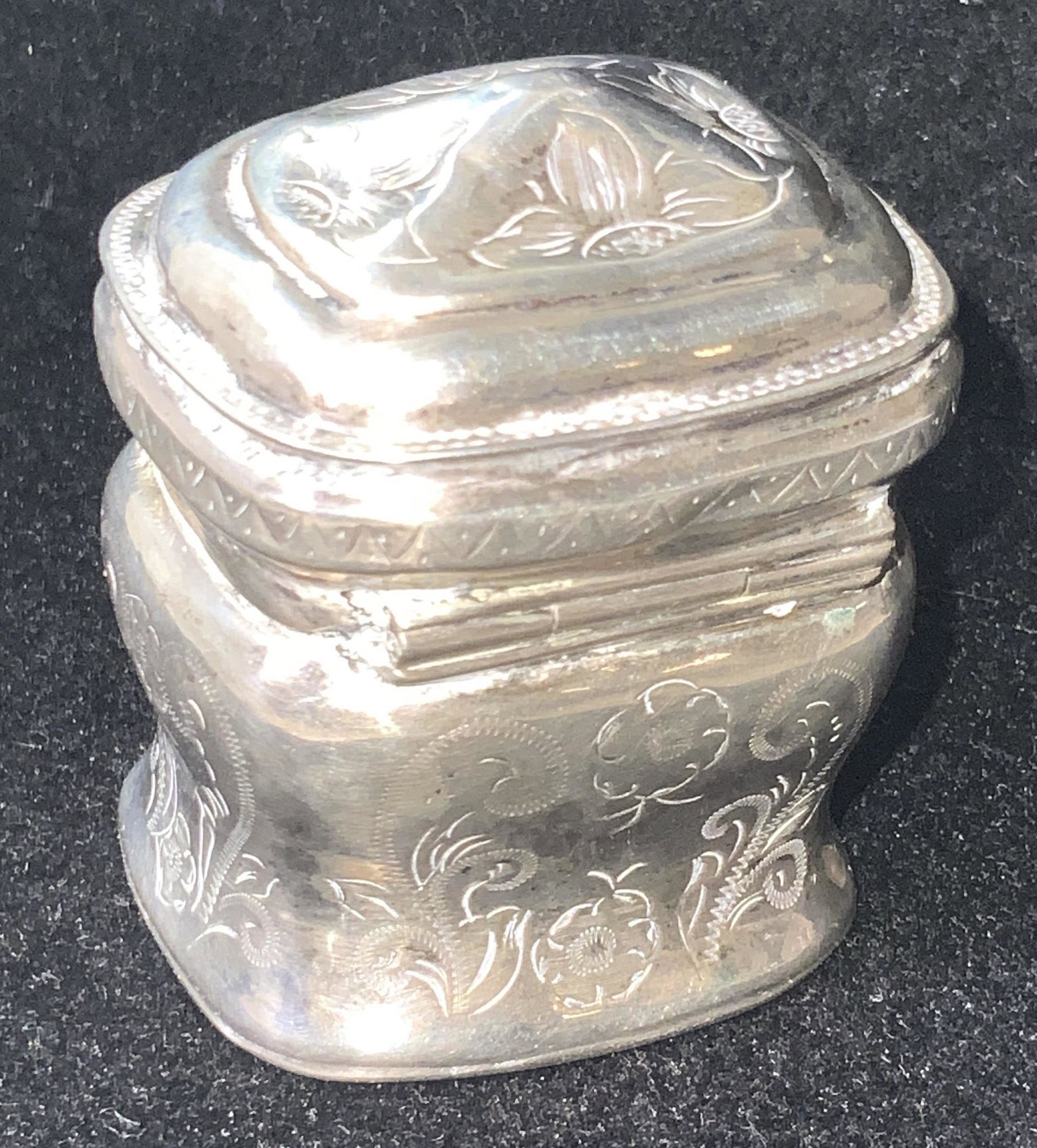 Antique Art Nouveau Style Dutch Sterling Pill Box: An antique (circa 1873) Dutch sterling silver pill box. This piece has hinge hardware that connects the base to the lid. The exterior detailing features intricately etched floral designs. Art nouveau 