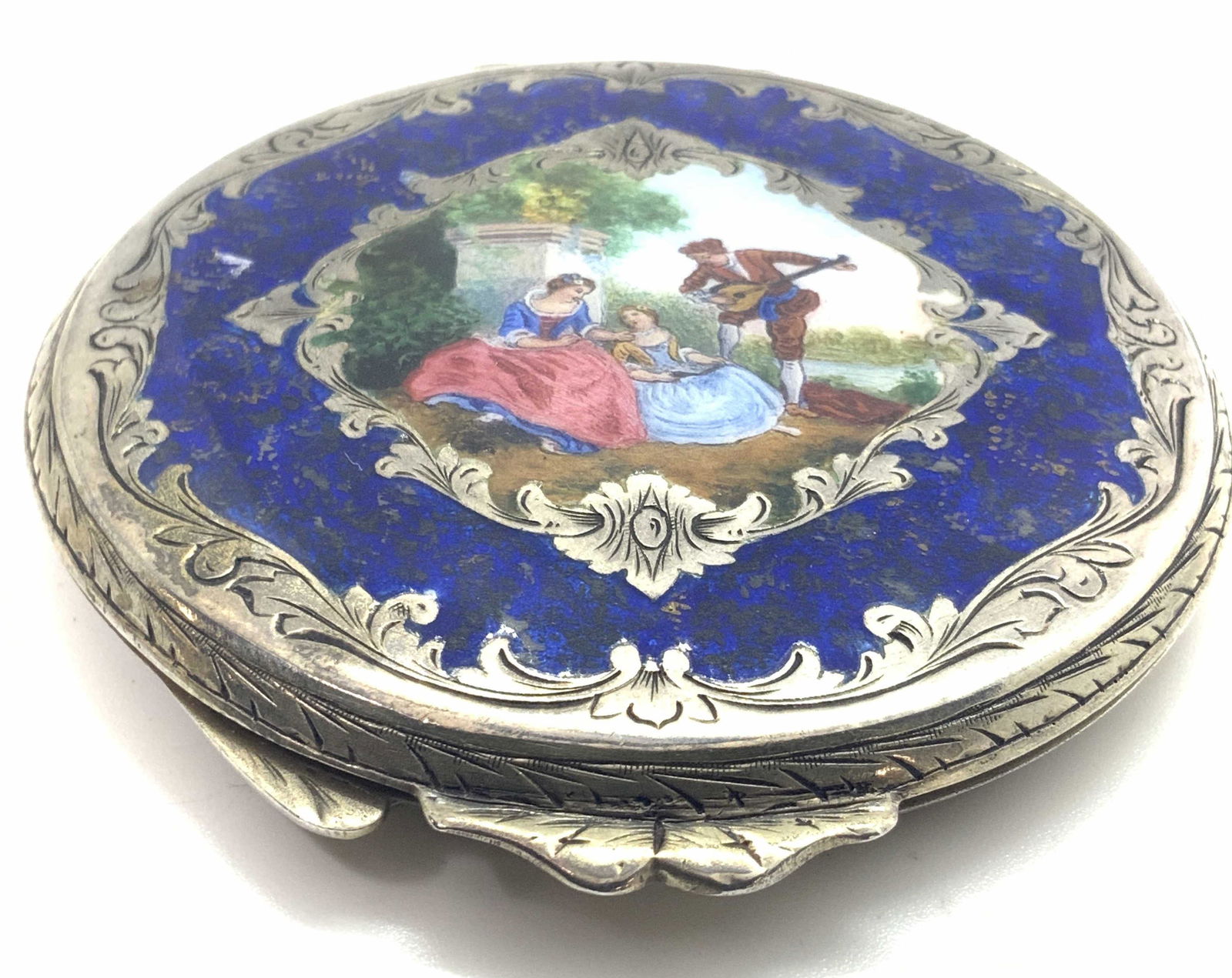Vntg Hand Painted Silver Enameled Compact Mirror: A vintage, possibly antique, silver enameled compact. This piece was once used for storing makeup. Precise hand painted, enamel, and hand etched designs along the from. The underside is completely cov