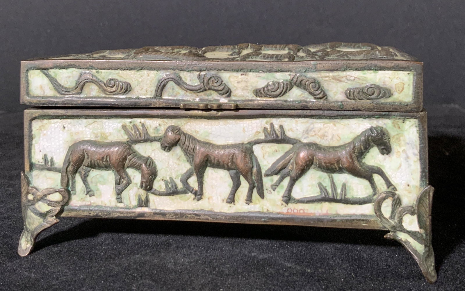 Vintage Asian HORSE MOTIF Keepsake Box: A vintage trinket box crafted from wood, copper, and composite materials. The metalwork is crafted from copper and features in relief etched horses throughout the design of the box. Beneath the horses