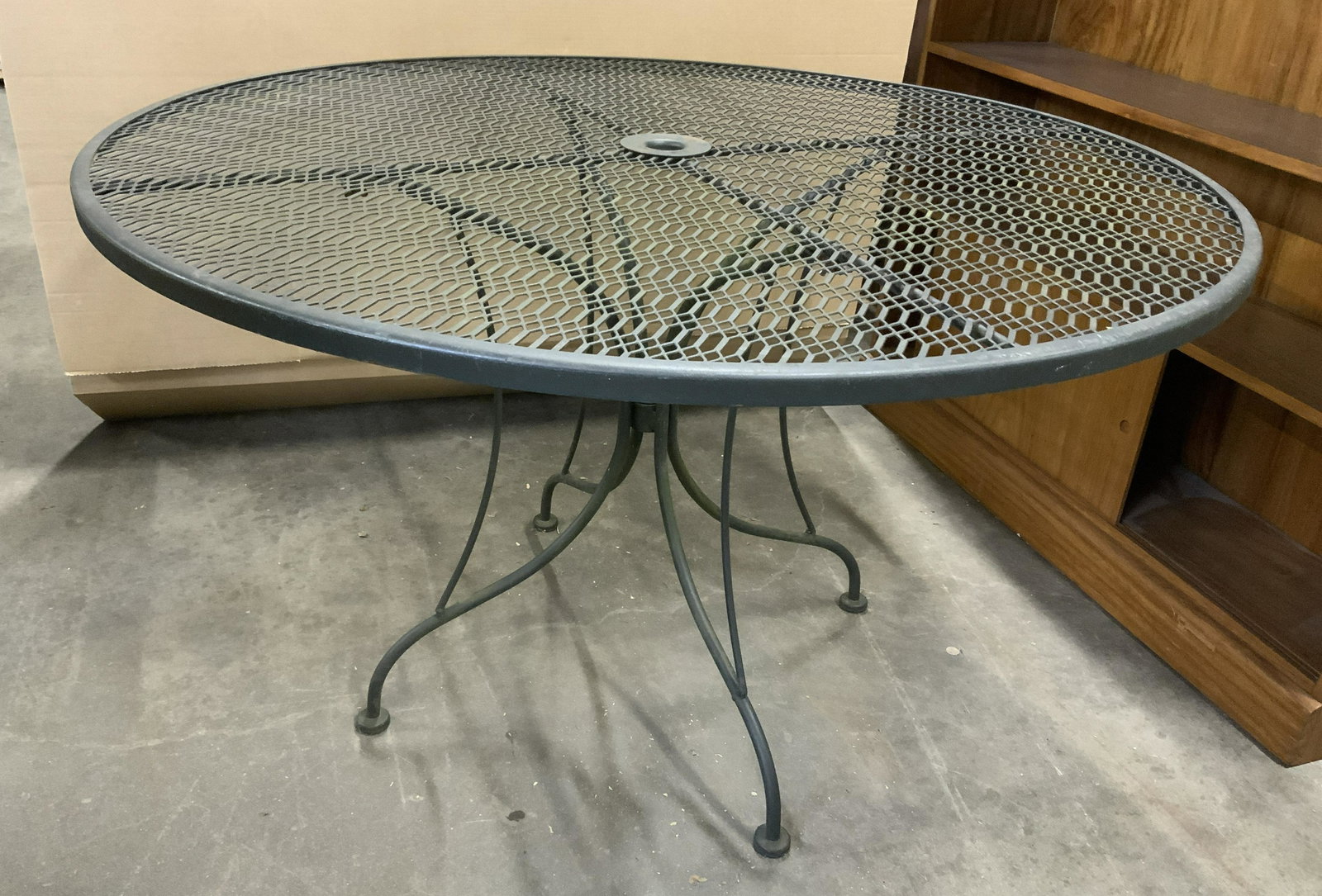 Metal Outdoor Patio Table: Metal patio table. Top is pierced, umbrella hole located in table center. Measures approx 28.5 inches H, and 48 inches in diameter. Wear is consistent with use. Metal table, outdoor furniture, indoor 