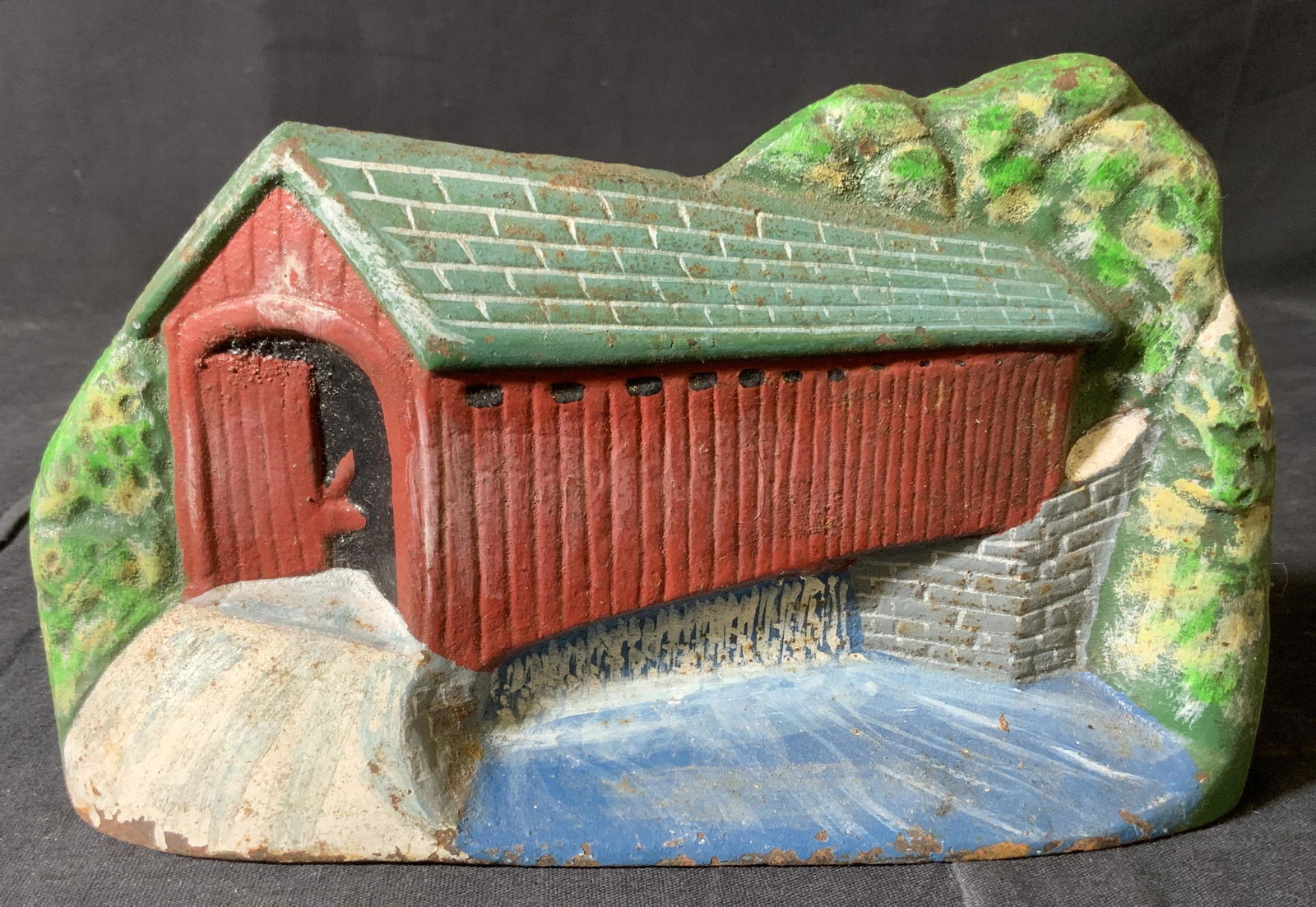 Vintage Cast Iron Covered Bridge Doorstop: Vintage Cast Iron Covered Bridge Doorstop, no apparent inscriptions or marks, measures 4 5/8 inches tall x 8 inches wide, some rusting and loss of pigment, Property of Janine Metz estate, social secre