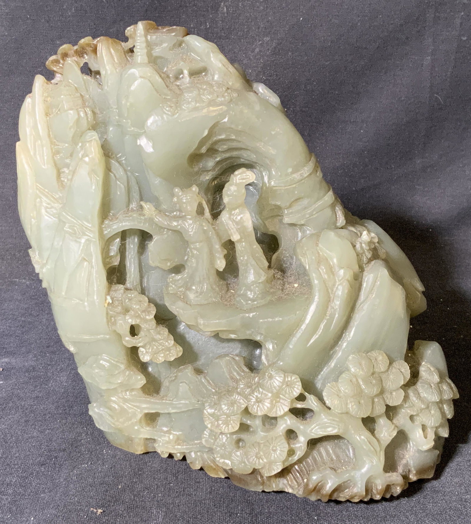Intricate Chinese Hand Carved Jade Sculpture: Intricate Chinese hand carved jade sculpture, no apparent inscriptions or markings, subject a mountainous scene with flowers and trees growing throughout with two women walking up it, piece carved in 