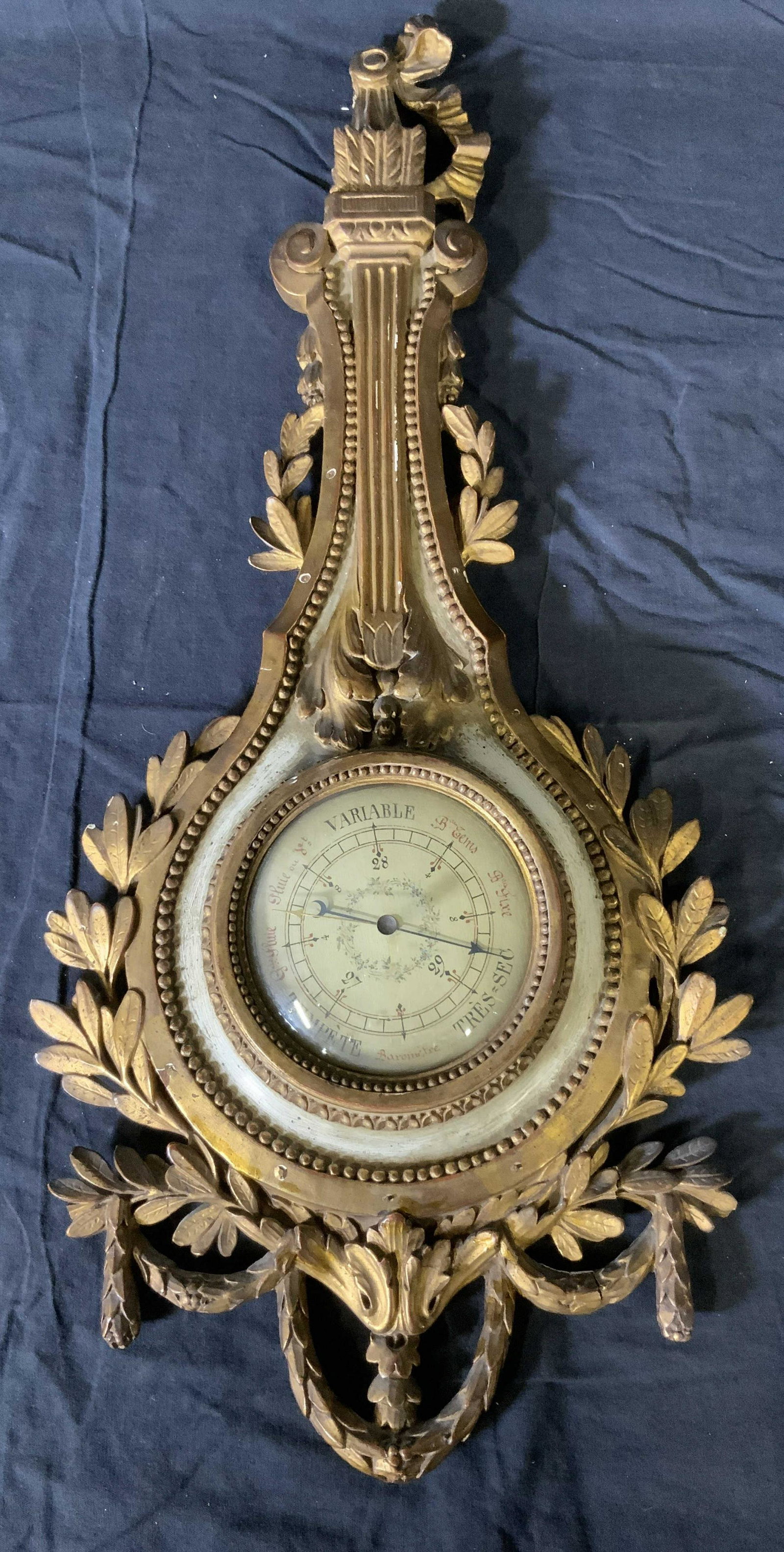 Vintage French Barometer W floral Frame: Vintage French Barometer, inscriptions to piece in French, measures 25 7/8 x 11 3/8 inches at widest point, some losses to wood, one detached piece is included, Property of Janine Metz estate, Social 