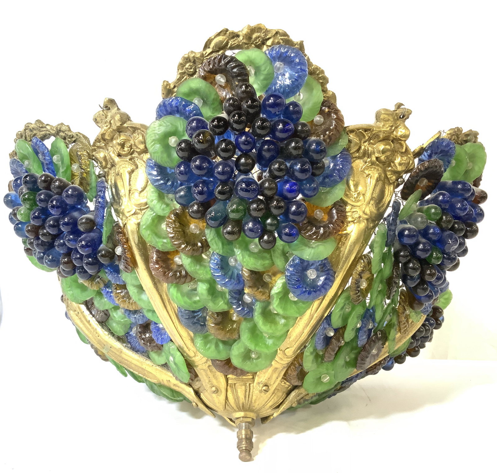 Vntg MURANO Venetian Glass Grape Floral Chandelier: Chandelier is possibly Dore bronze Ormolu possibly brass. Piece is vintage possibly antique. Piece has multi toned floral & grape cluster detail with tones of green, amber & blue. Chandelier has ornat