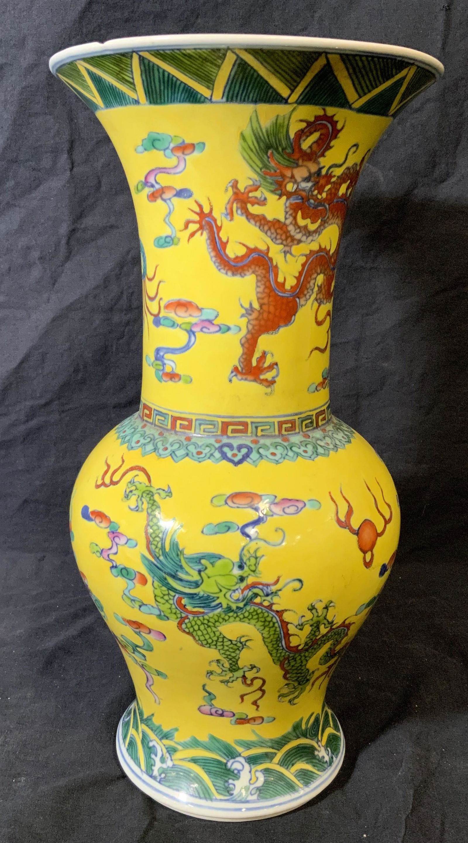Chinese Porcelain Hand Painted Vase: Chinese Porcelain hand painted vase, Chinese stamp to underside, exterior painted a bright yellow with dragons waves and geometric designs, chip to rim of vase, measures approximately 15 inches at tal