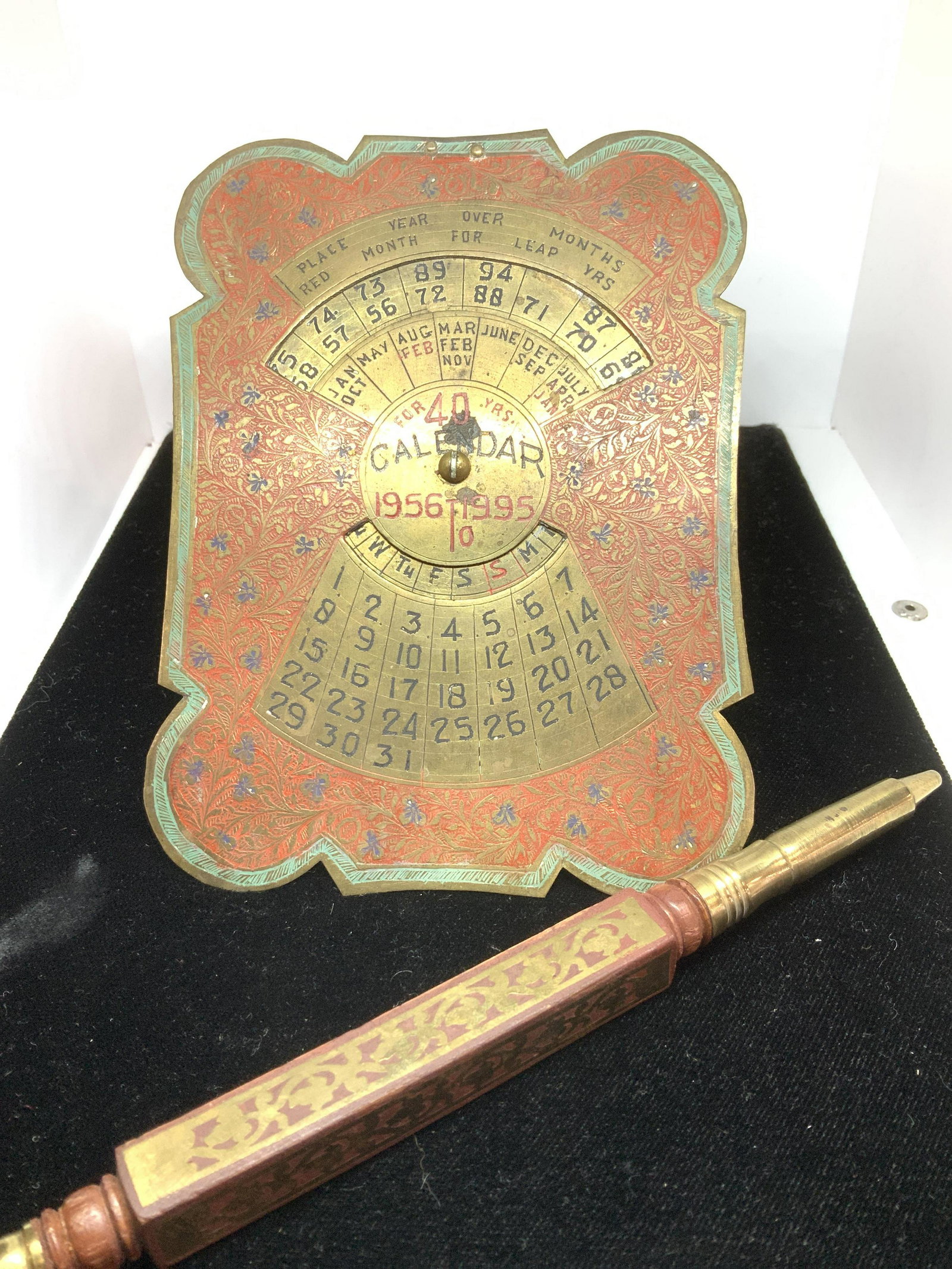 Vintage Collectible Enamel Brass Desktop Set 2: Intricately carved and enameled brass tabletop calendar, stands on desk or table like a frame. Brass dial turns to set day of week and years. 5.5 x 4 in. Wood Writing plume holder with pierced brass d