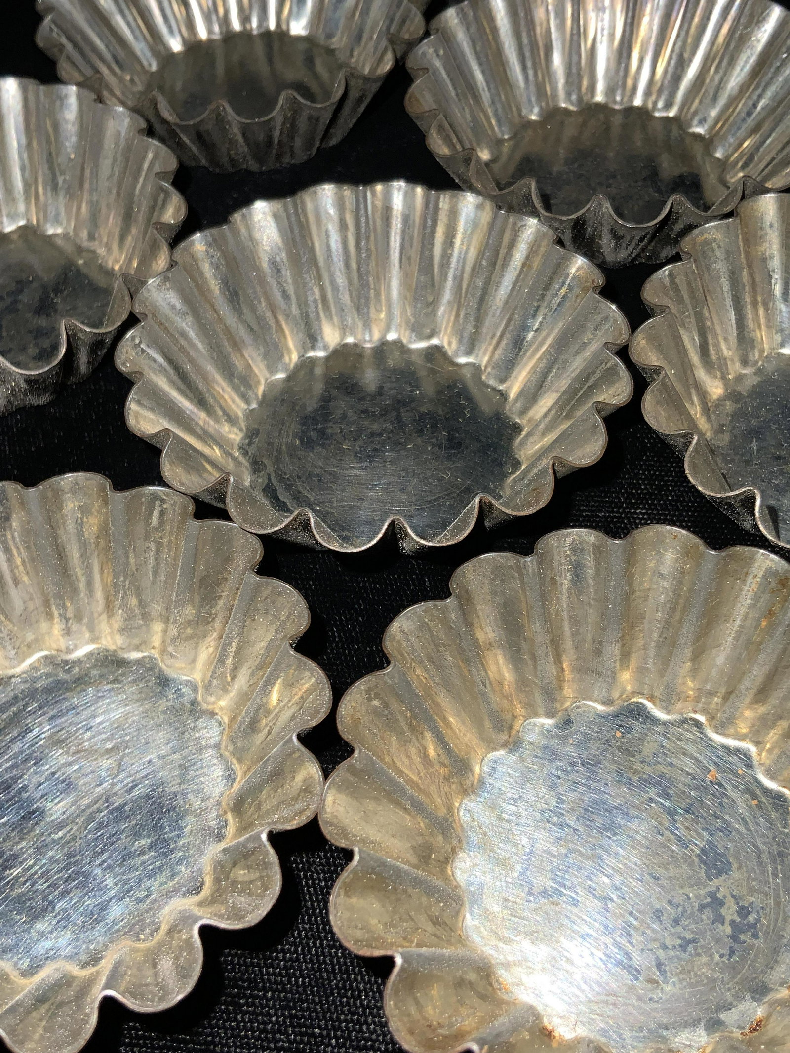 Set 10 Vintage Metal Cupcake Liners, Kitchenware: Ten pieces of vintage silver tone metal cupcake liners. Each piece is scalloped and polished on the underside. Mild wear to metal. Pieces can be up cycled into nut dishes, ring dishes, trinket dishes,