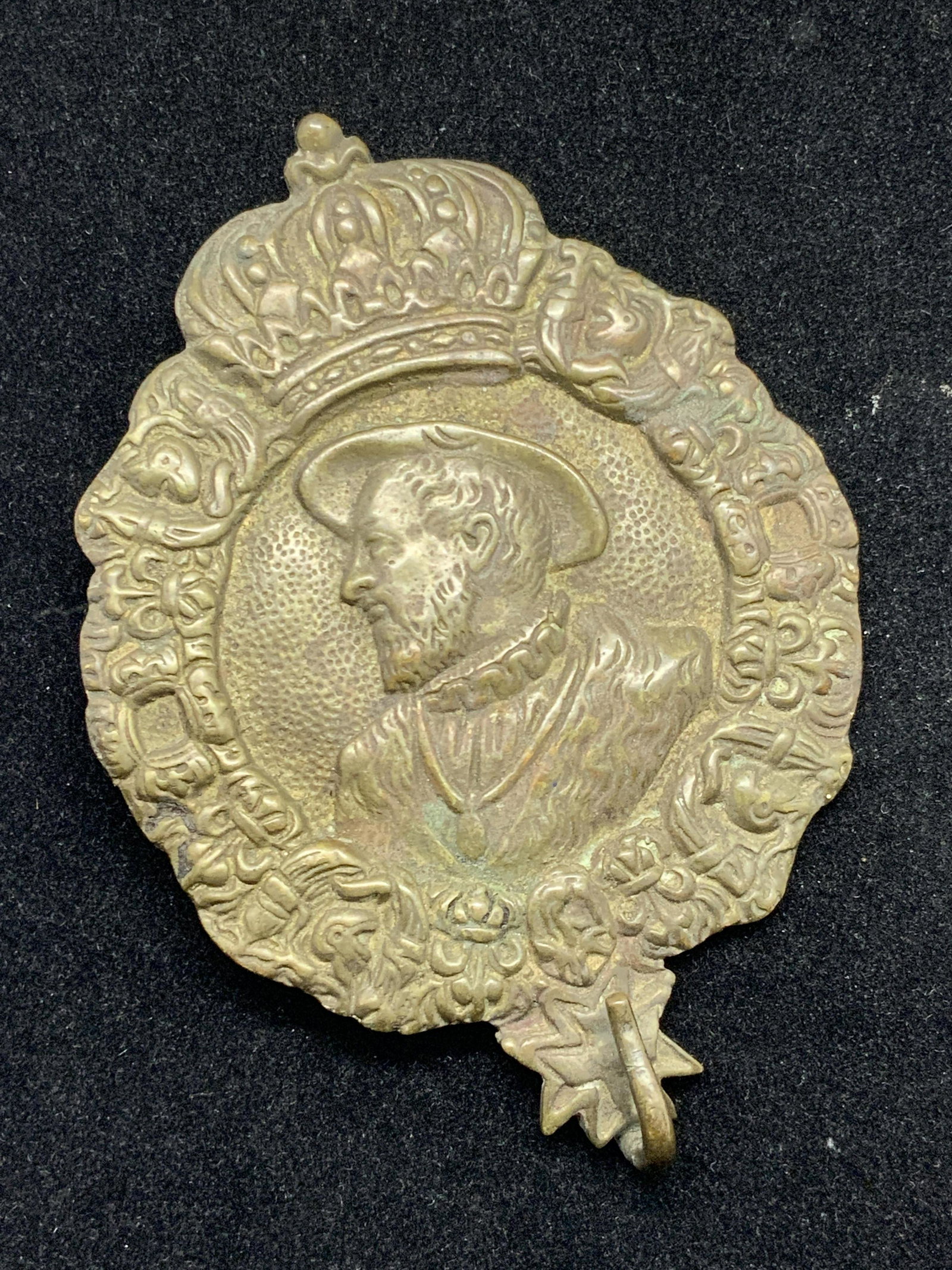 Vintage Male Side Portrait Wall Accessory: A vintage metal wall accessory. The piece has a bail and jumper ring on the back, can possibly be used to hang or display the piece. A hook is present at the base. Can be used to hang other items off 