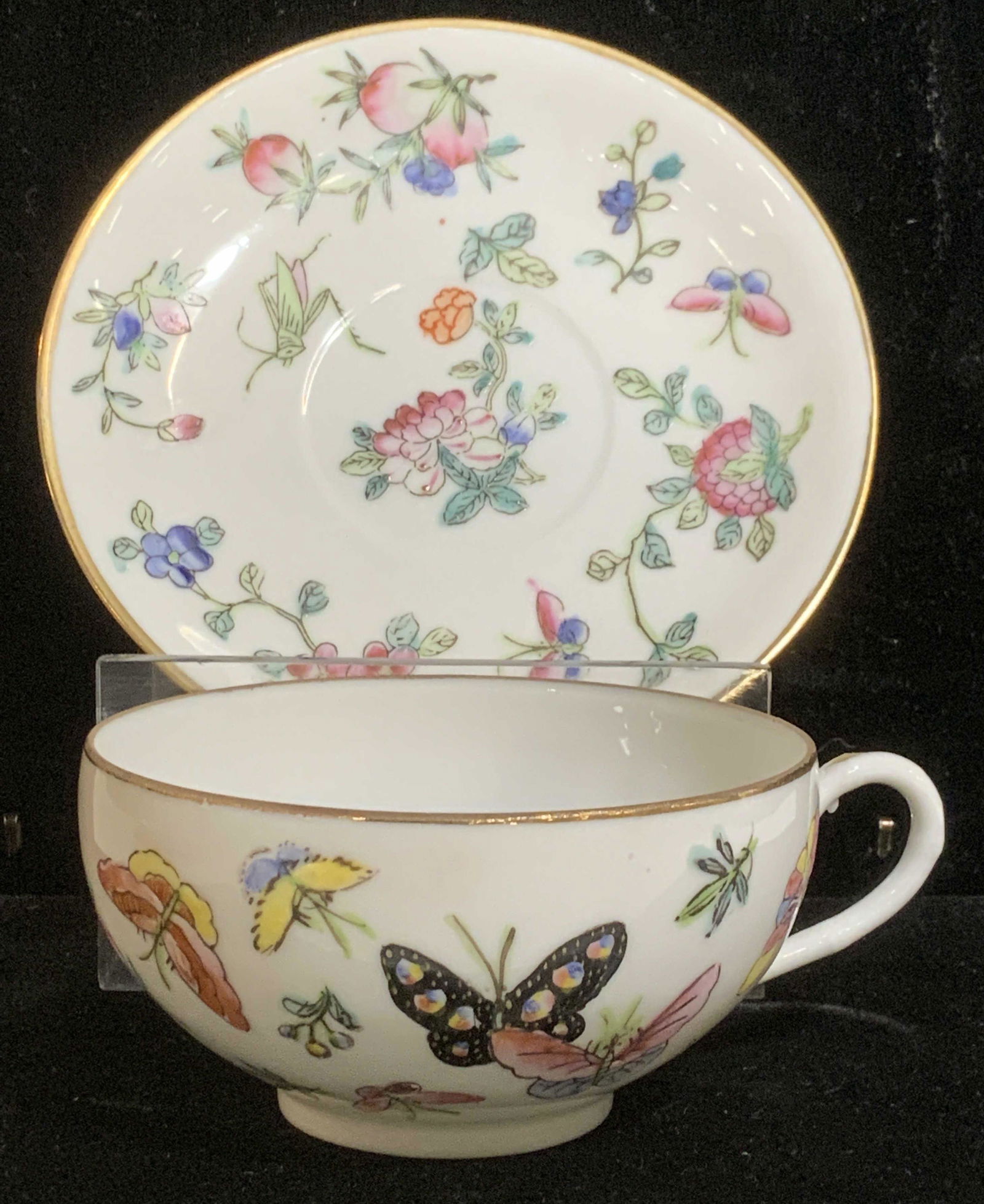 Fine Bone China Tea cup & Saucer, Japan, signed: Fine Bone China, hand painted in Hong Kong, Hallmarked with Chinese stamp in red ink. Translucent China is the finest of porcelain, delicate and fancy. This pair depict famille rose, butterflies, Japa