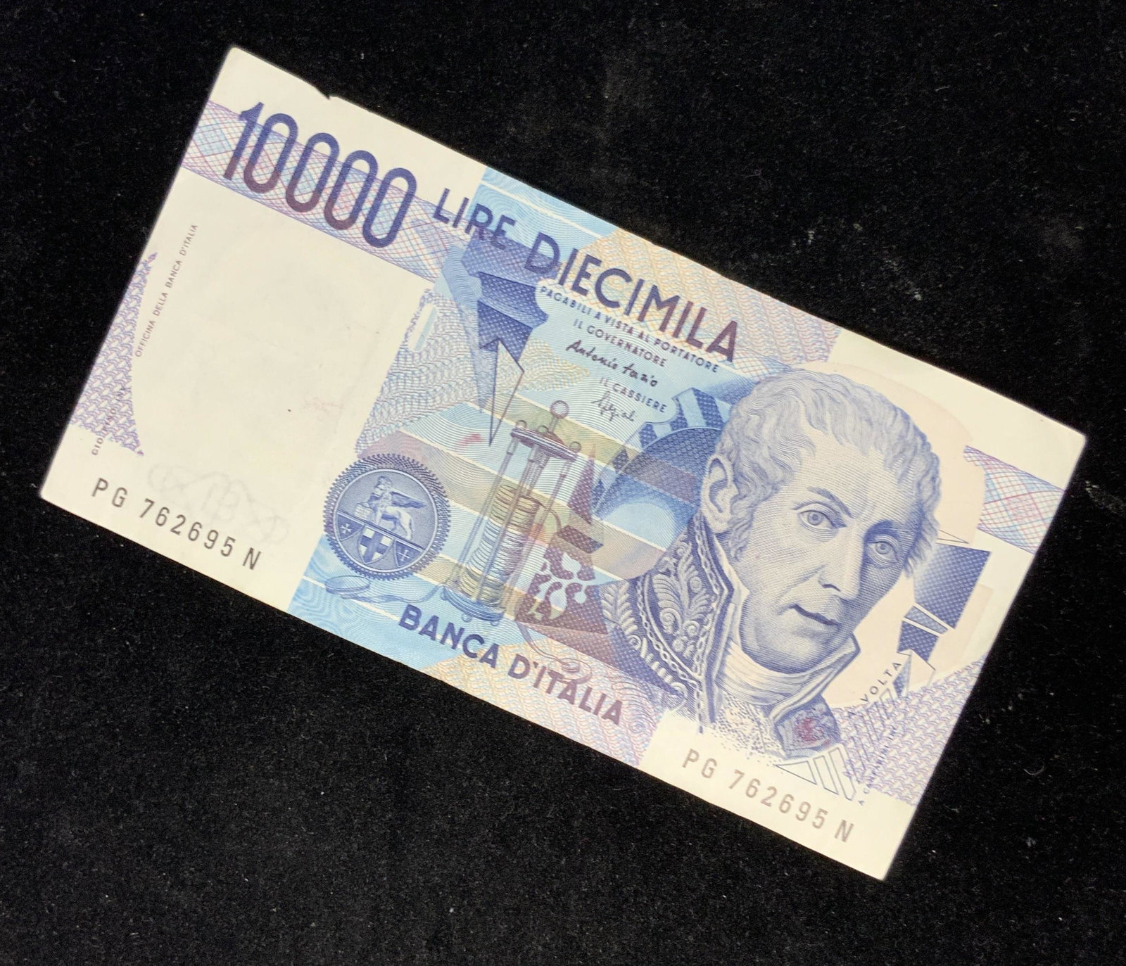 Vintage Italian Currency Lire Diecimila, A. Volta: This vintage, 1984, lire diecimila (10000) banknote portrays the image of Alessandro Volta, Italian physicist and inventor of the battery. The words ‘Banca D’Italia’ are printed on the paper not