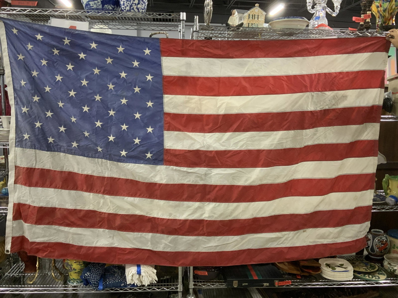 COLLECTIBLE GRAND AMERICAN FLAG, 7 ft.: American flag, 50 stars machine embroidered. 7 ft. 9 in. L 4 ft. 8 in. W. Two brass grommet holes for outdoor flag pole. Property of Janine Metz estate, Social Secretary to British Royals the Duke & D