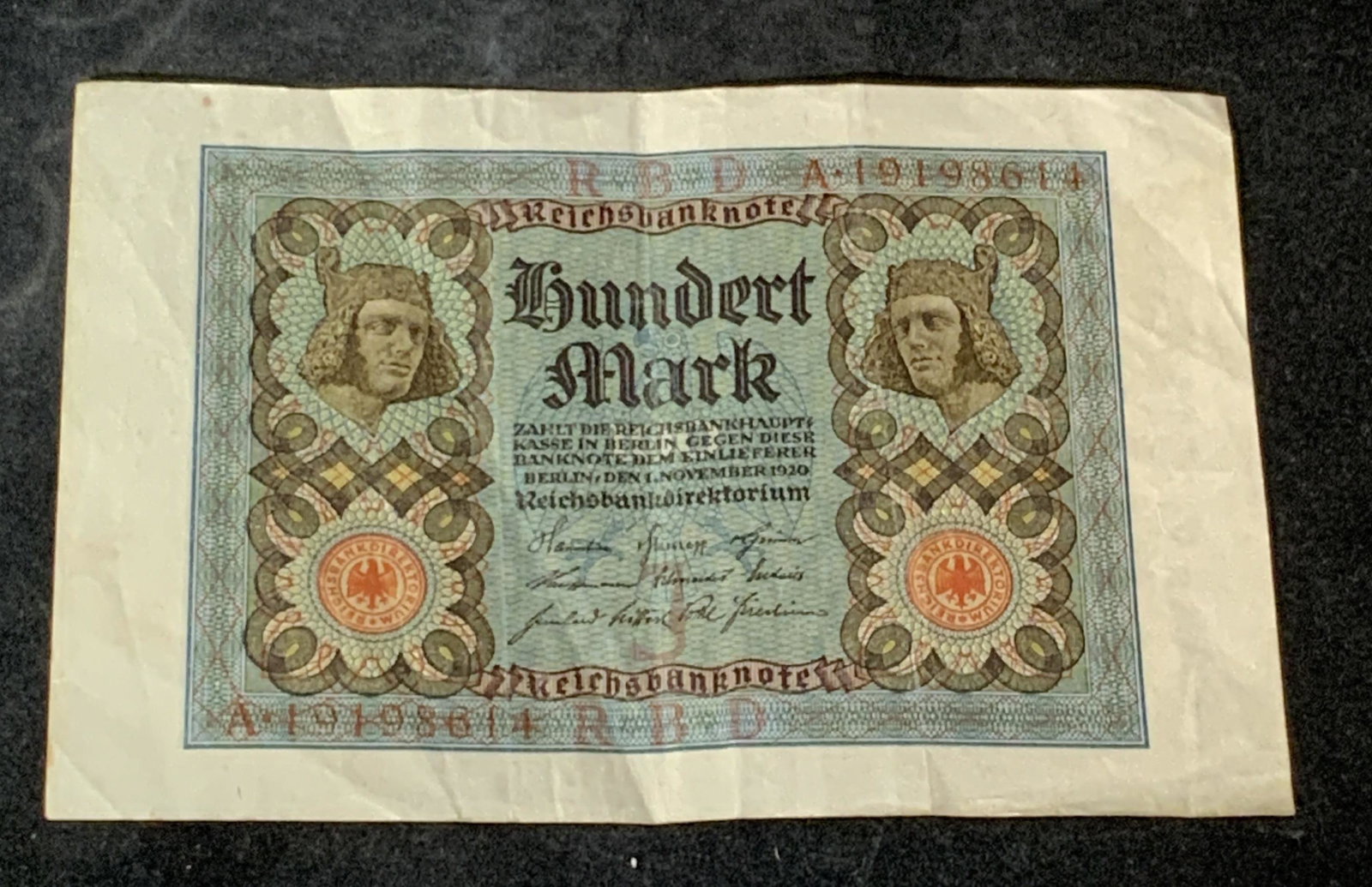 Antique 1920 German Currency, Hundert Mark: A 1920 antique German Banknote. Obverse depicts Head of the "Bamberg Horseman" in Bamberg Cathedral. Back: Floral rosette design. Text on obverse read: Reichsbanknote. Hundert Mark zahlt die Reichsban