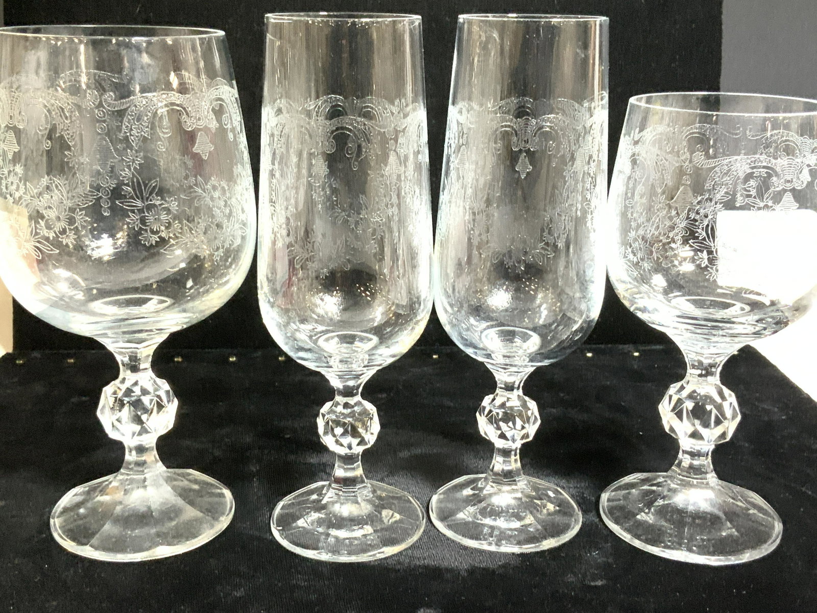 Set 10 Etched Crystal Stemware, vintage: Captivating flower weather design, etched into crystal set of stemware. Possibly from France. 2 wine glasses, 6 champagne flutes, 2 wine goblets. Short cut crystal stem. Flute height 6.75 in. wine gla
