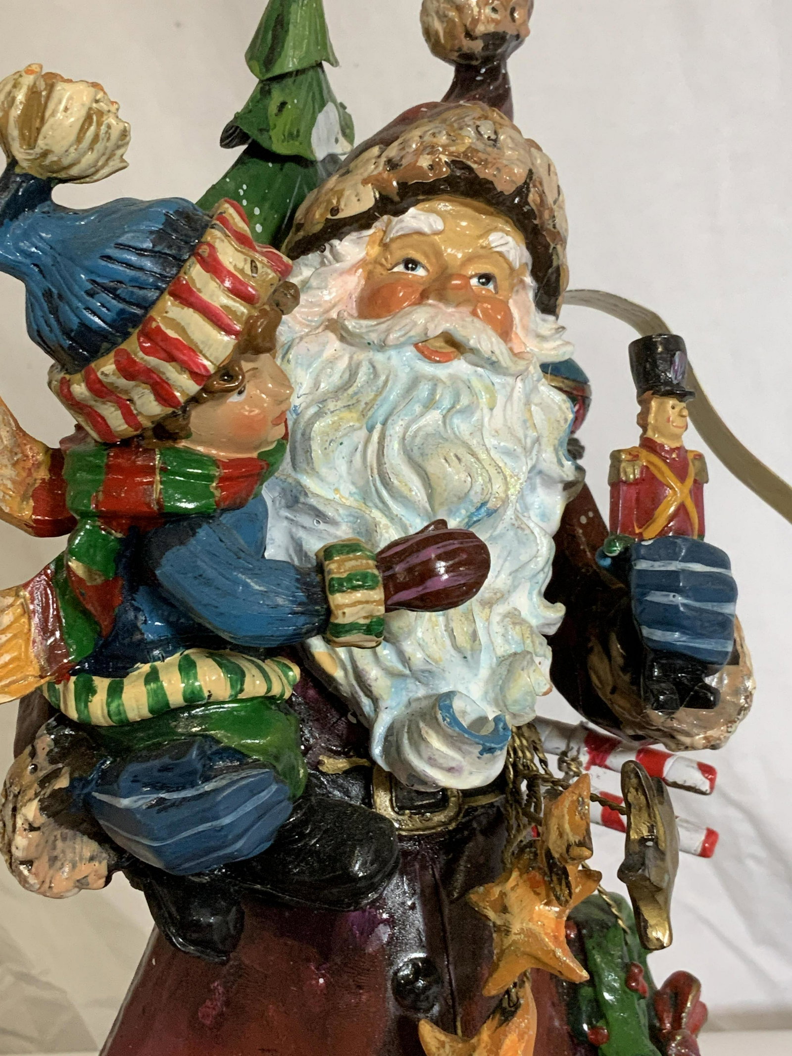 Lot 7 Vintage Christmas Decor and Accessories: Tabletop sculptural decor of Kris Kringle/ Santa Claus , one all Toleware 11.5 in. Ht by 8 in. W, and one composite Santa figural,hand painted. Lightweight glitter and glass church ornament, figurines