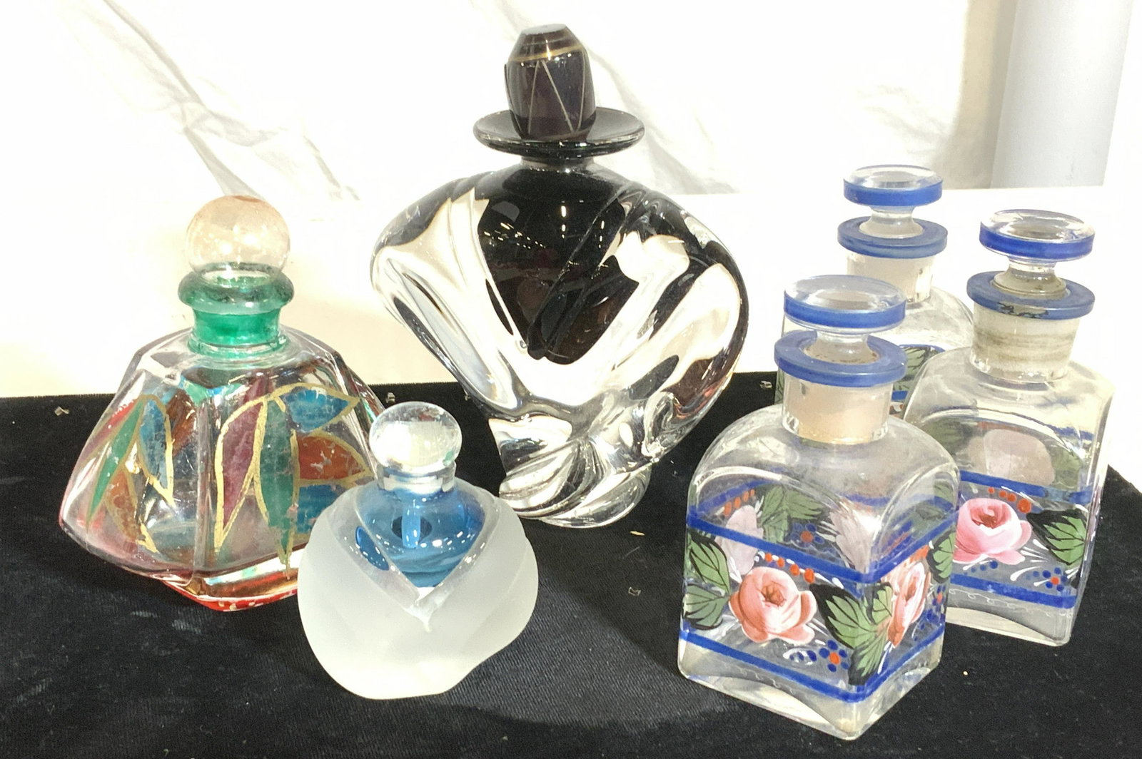 Lot 6 Art Glass Perfume Bottles/Apothecary Bottles: SIGNED GRAND perfume bottle underside handwritten by artist ‘ M. Trimble 89’ heavy glass bottle with art decor design. Finial sits on opening. 4.5 by 4.5 in. Set 3 matching hand painted bottles wi