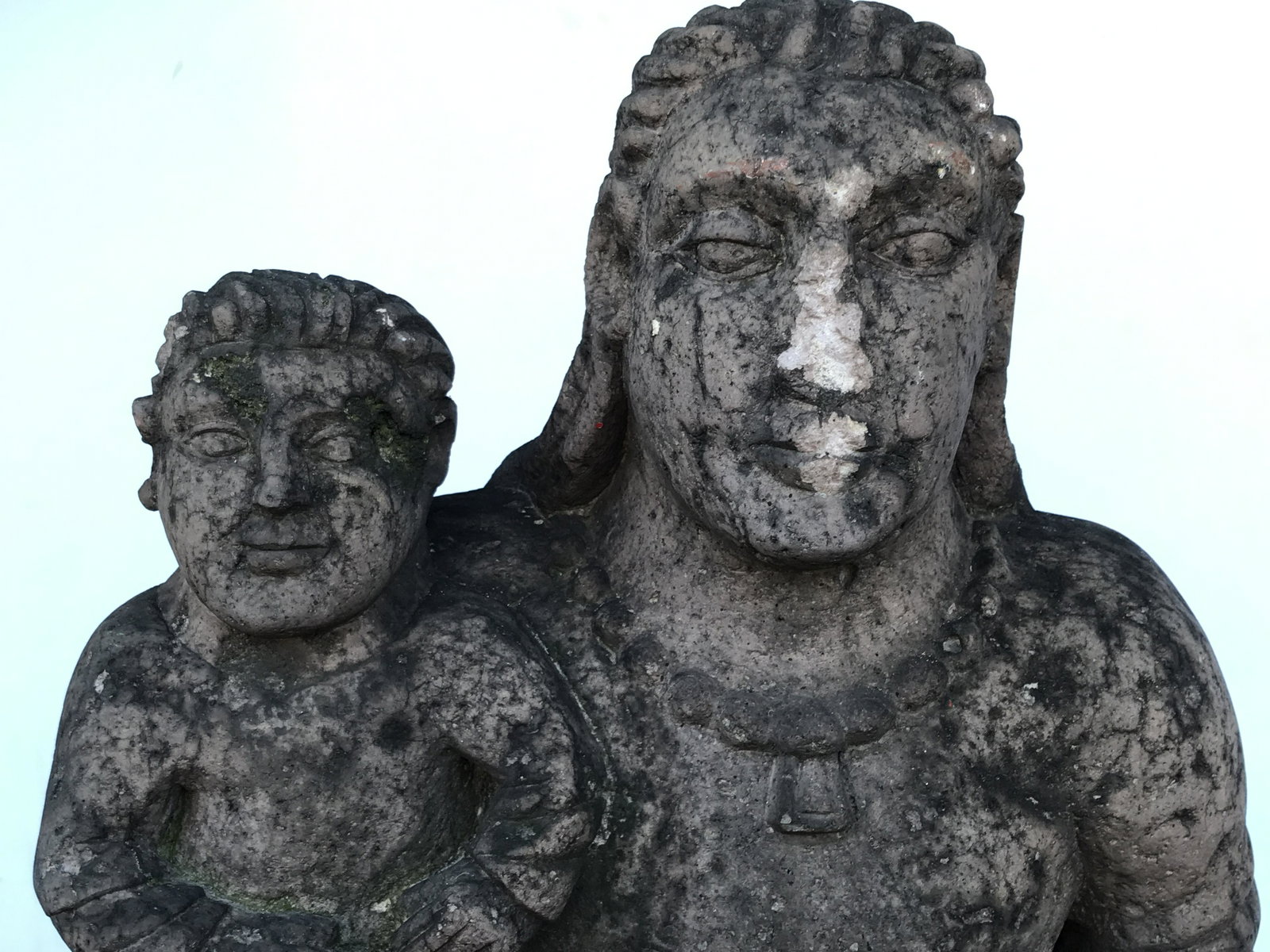 Antique Byzantine Style Outdoor Statue: Antique Byzantine Style Outdoor Statue Large figure in robes holding child. Stone style, appears to be cement. Missing nose on main figure, evident surface wear and weathering from exposure. 33 in tal