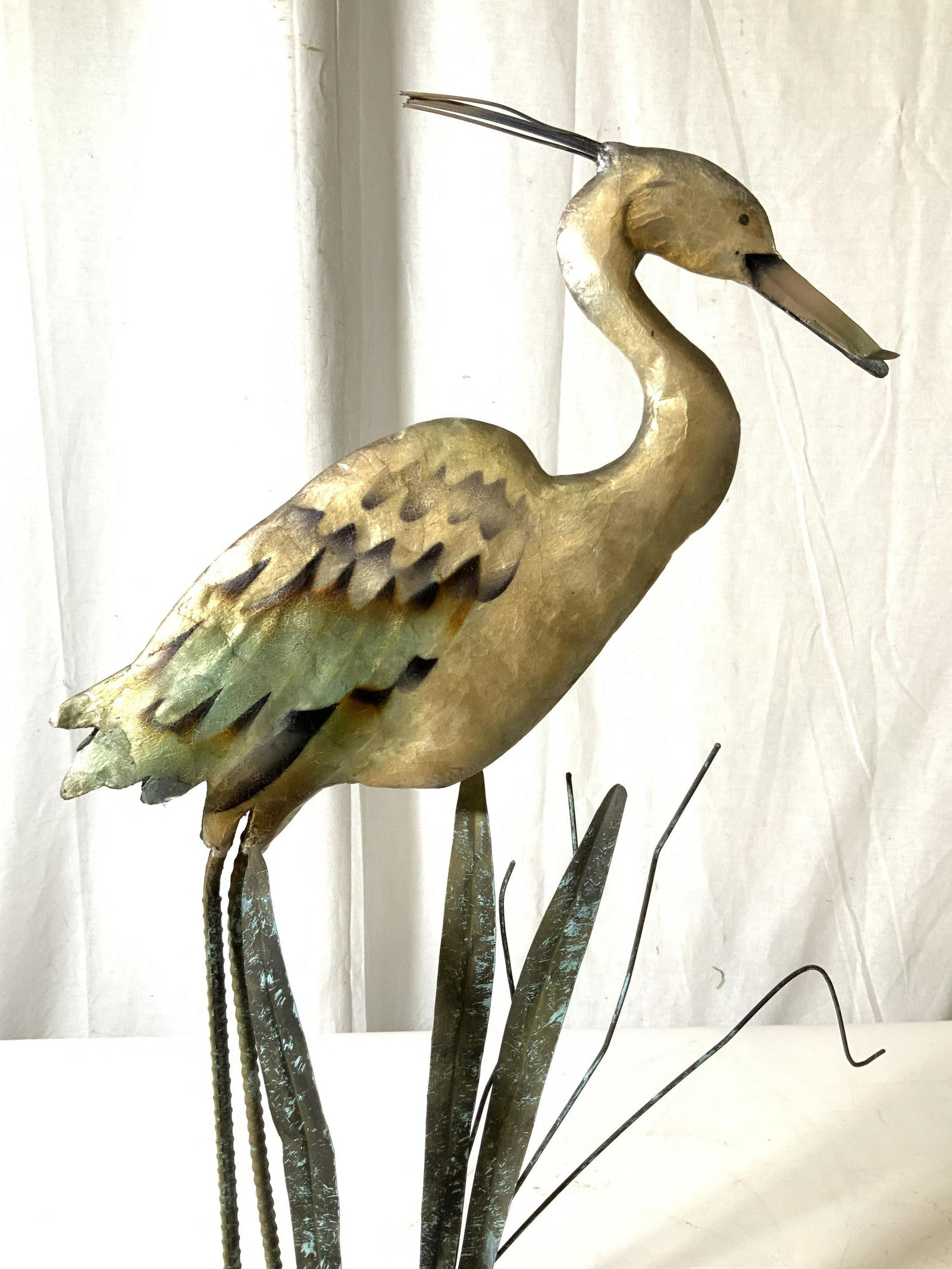 Antique Painted Metal Stork Sculpture: Folk art, whimsical hand formed metal sculpture of wading bird, stork, egret with leaves standing in marsh land, decorative arts, wood and metal base, measures ht 24 inches, width app 12.5 inches dept