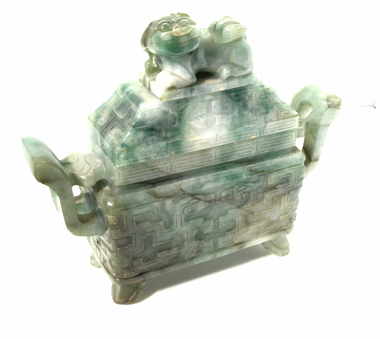 Carved Mottled JADEITE FU DOG Lidded Trinket Box: Hand carved Asian mottled jadeite lidded trinket box. This piece features intricate openwork and incising all along the piece. In relief carvings of dragons on both sides of lid and base. The natural 