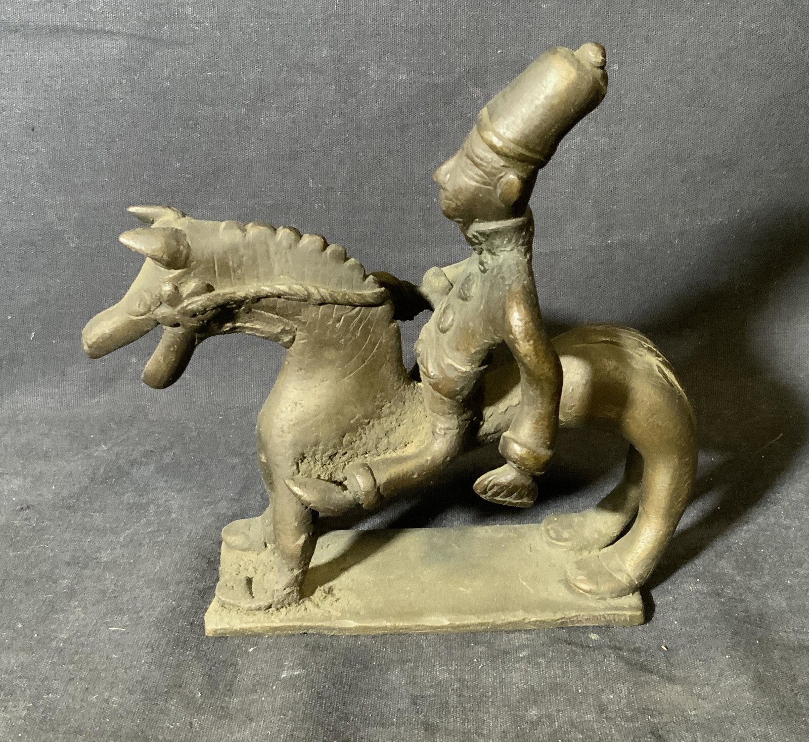 Bronze Equestrian Horse w Rider Statue: Bronze equestrian statue, possibly Middle Eastern in Origin,, subject an equestrian sculpture showing a man in a fez and button shirt atop a stylized horse, piece attached to its base, measures 6 inch