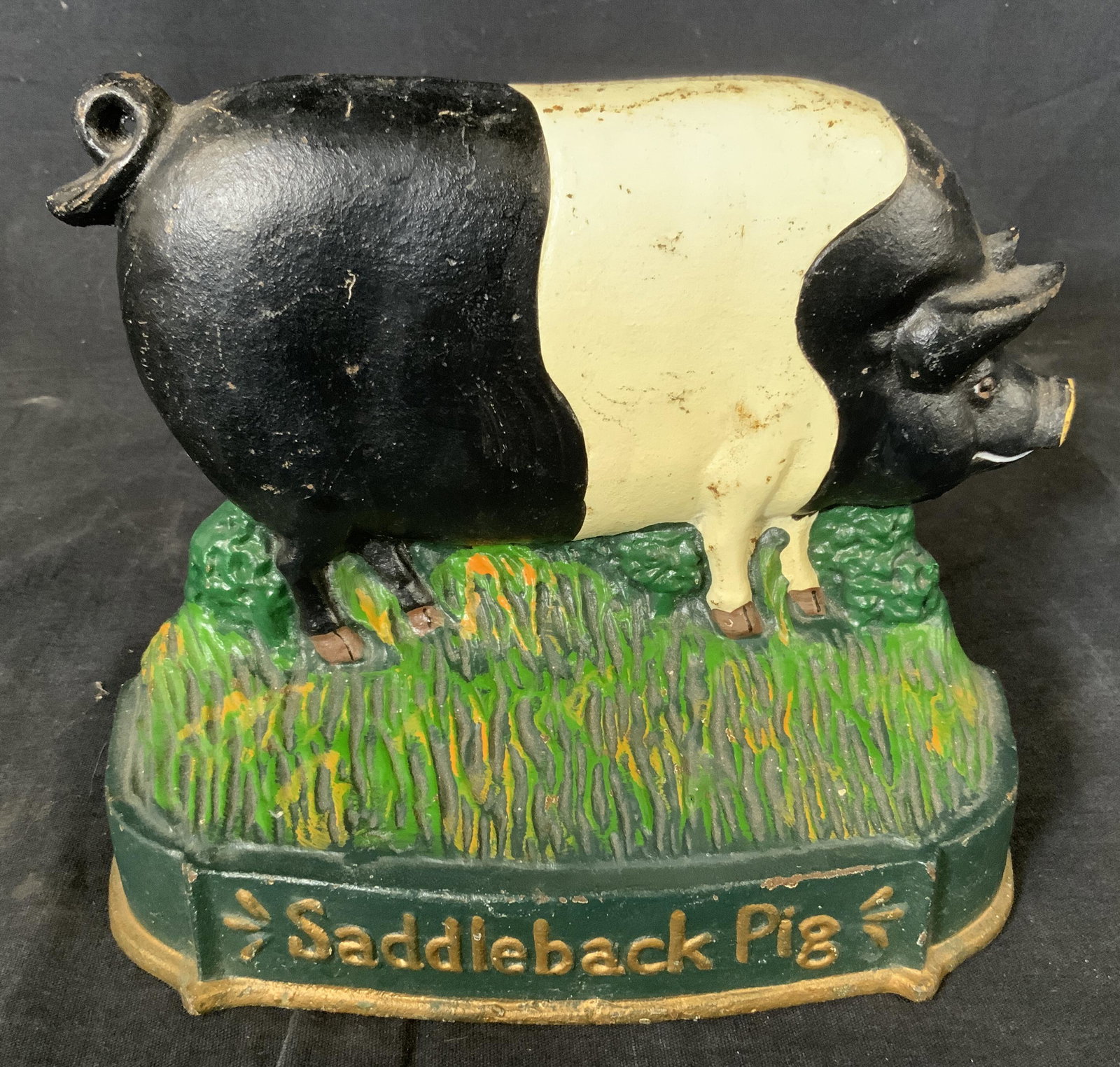 Vintage Cast Iron Saddleback Pig Doorstop: Vintage Cast Iron Saddleback Pig Doorstop, possibly antique, inscription to piece reads ‘Saddleback Pig’, measures 6 1/4 x 7 3/4 inches at widest point, some rusting and loss of pigment to piece b